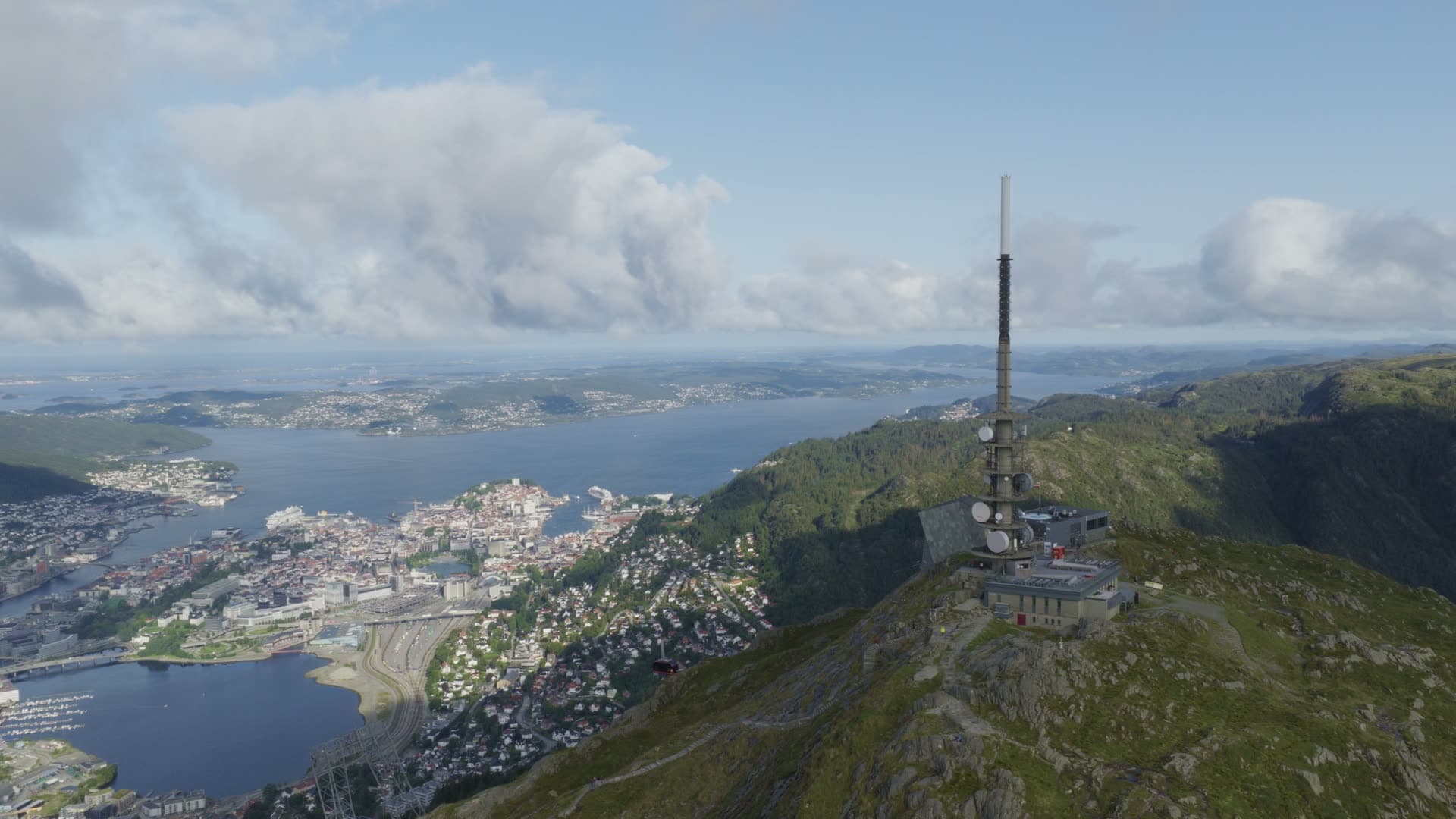 Communication tower on mountain overlooking city, Alrekstad