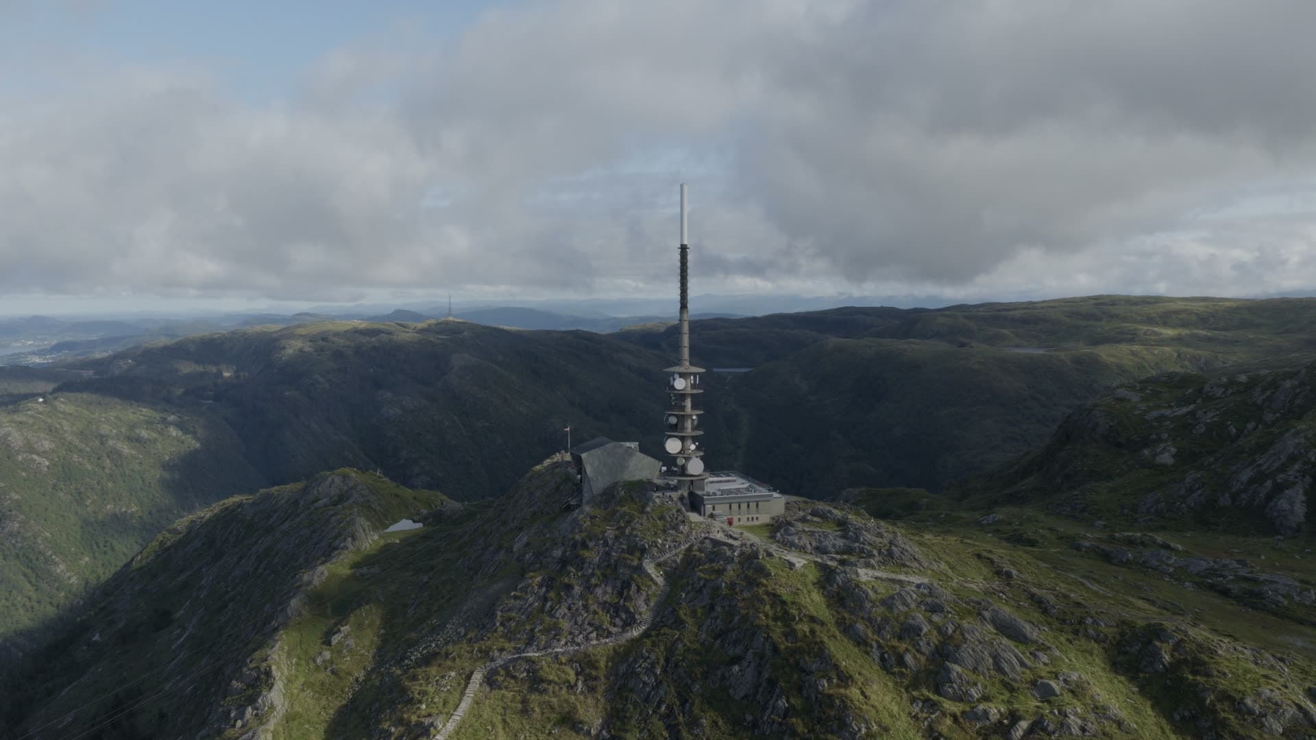 Radio transmission tower on mountain peak, Alrekstad