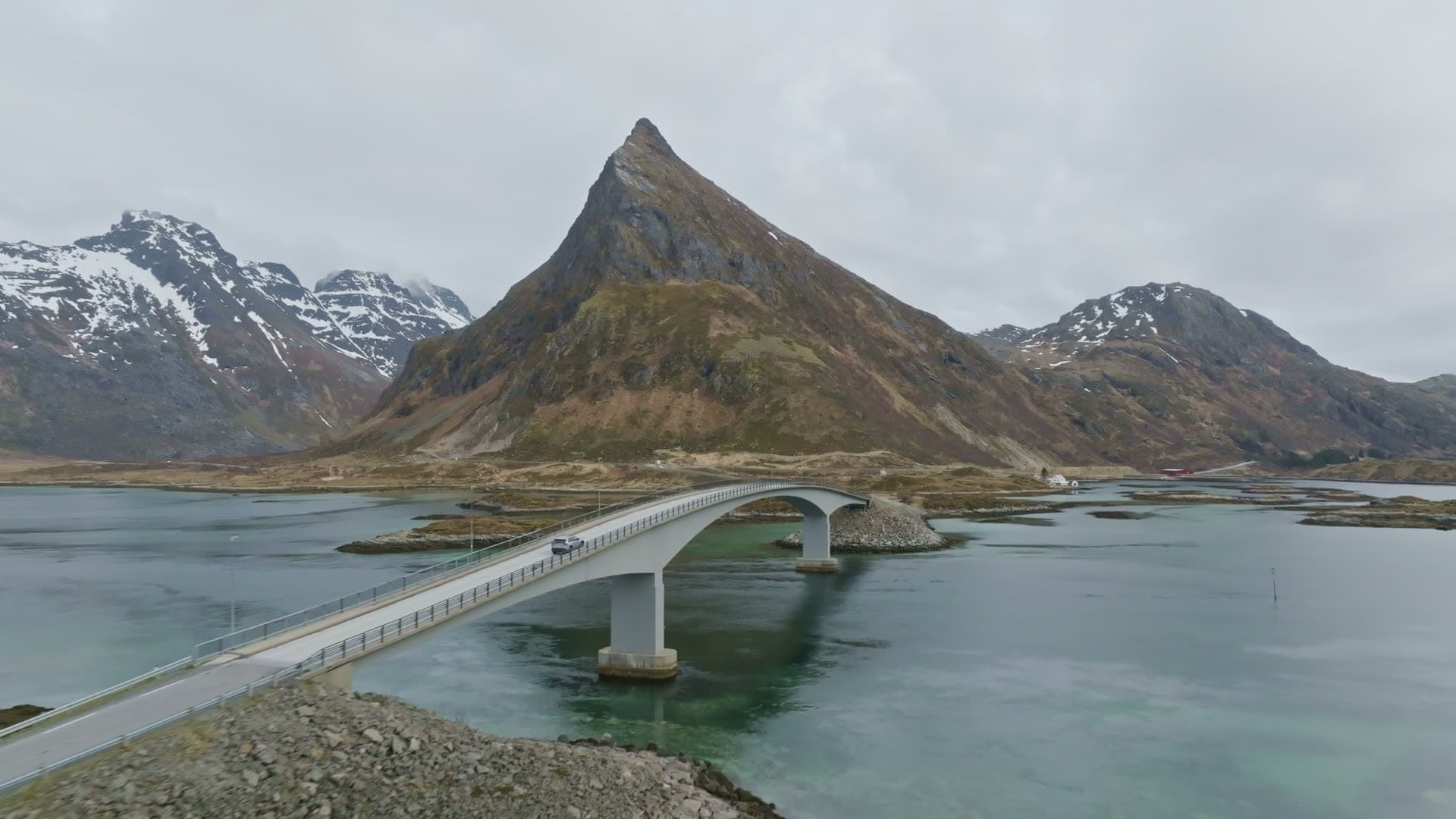 Bridge across glacial fjord with mountain, Flakstad