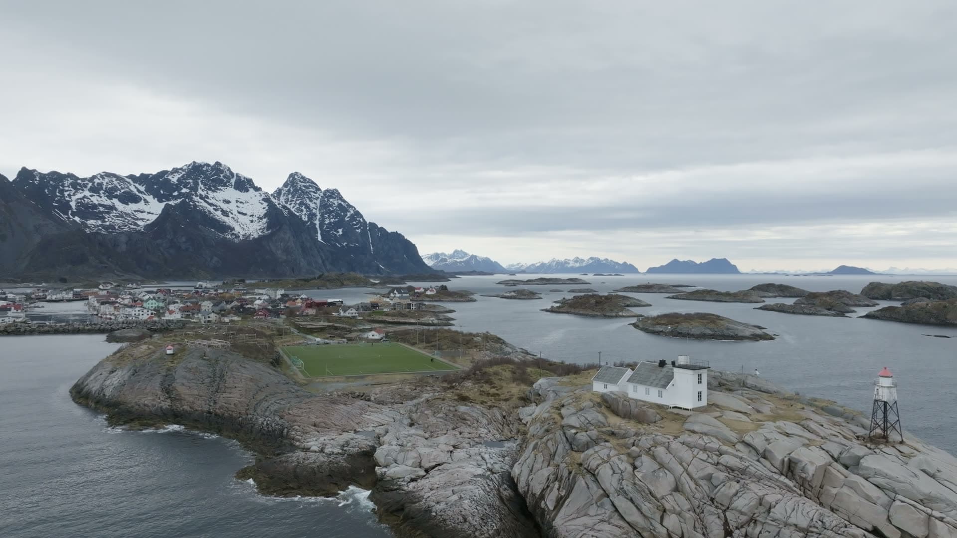 Lighthouse on rocky coastal peninsula, Henningsvær