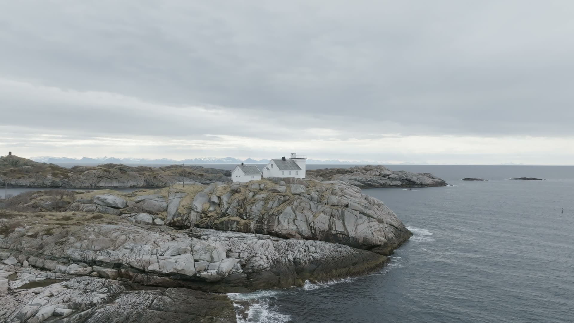White house on remote rocky headland, Henningsvær