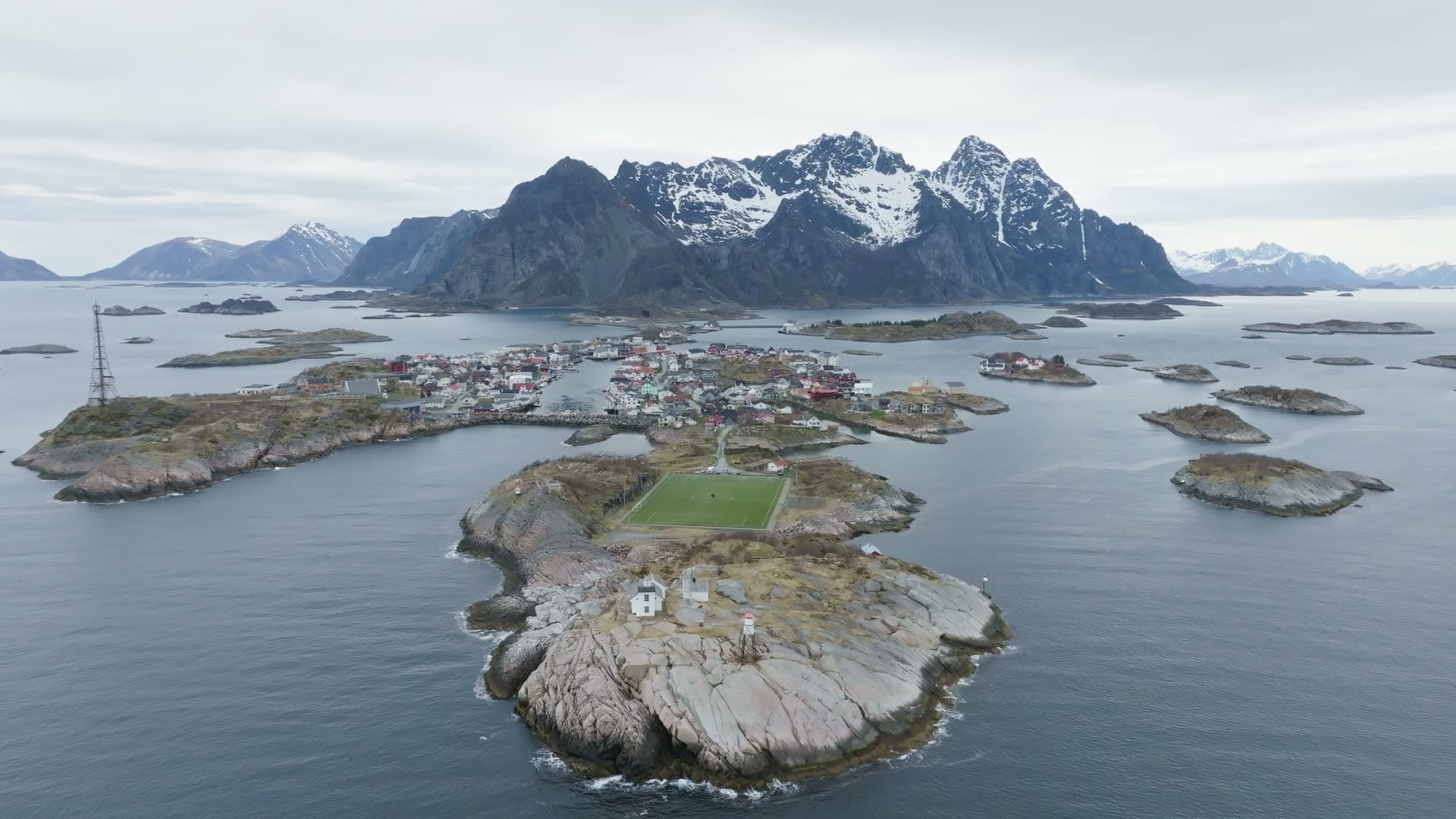 Remote island community with mountain backdrop, Henningsvær