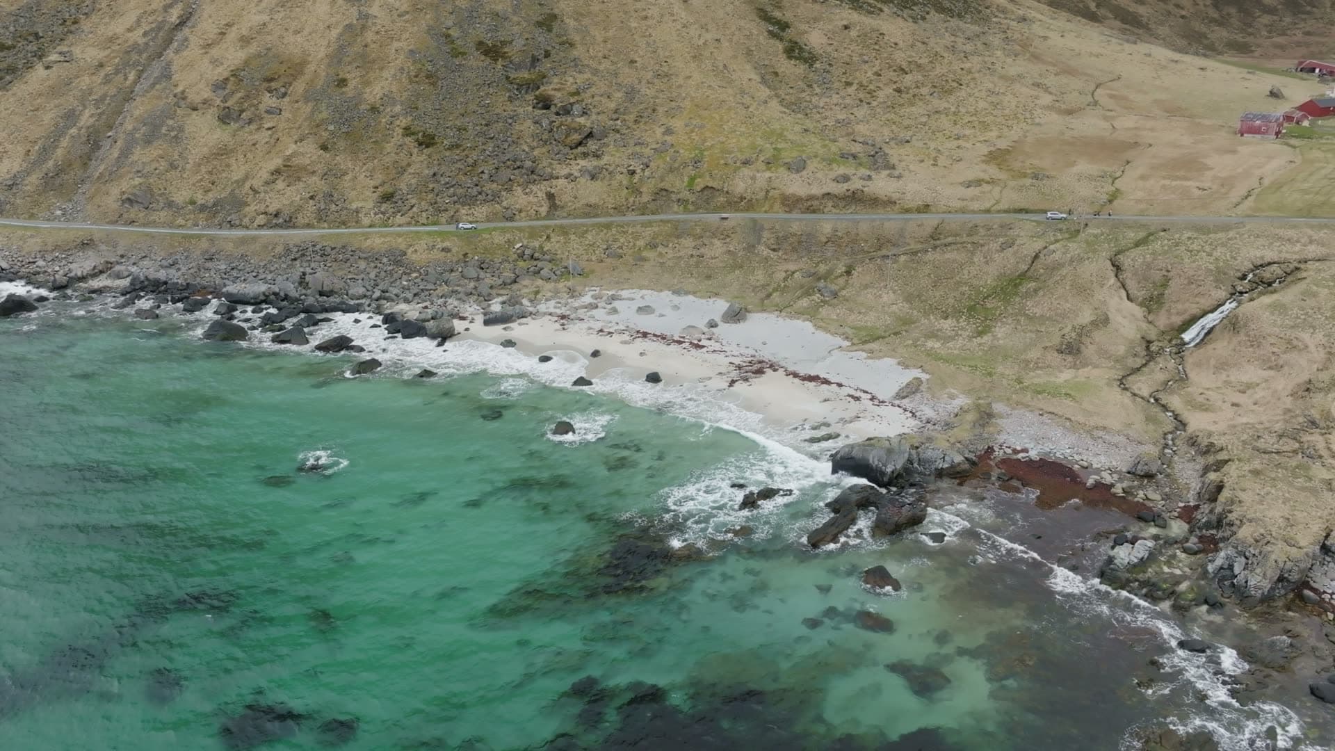 Remote Arctic coastal settlement and turquoise bay, Myrland