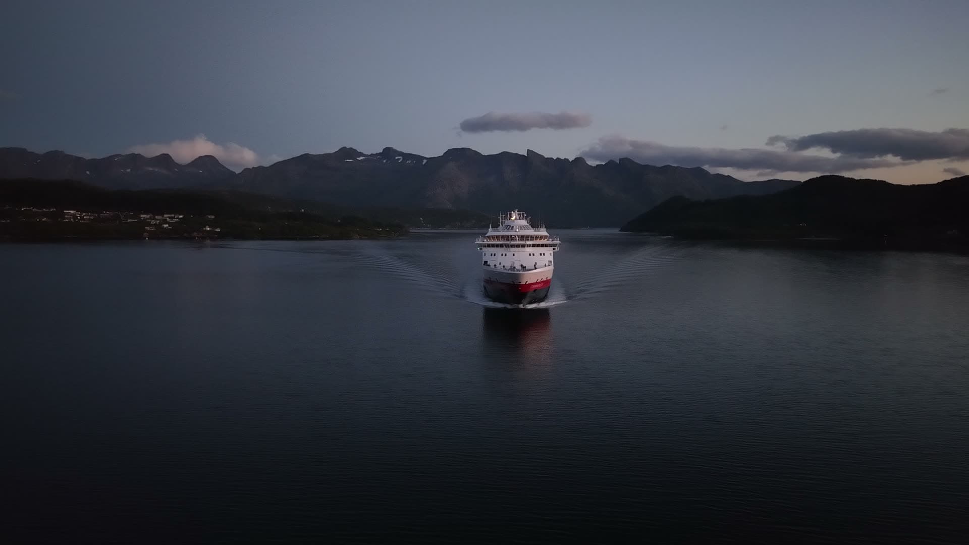 Cruise ship entering fjord at twilight, Ørnes