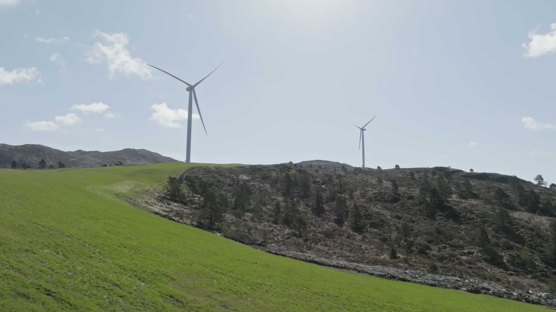 Wind turbines on grassy hillside, Fitjar