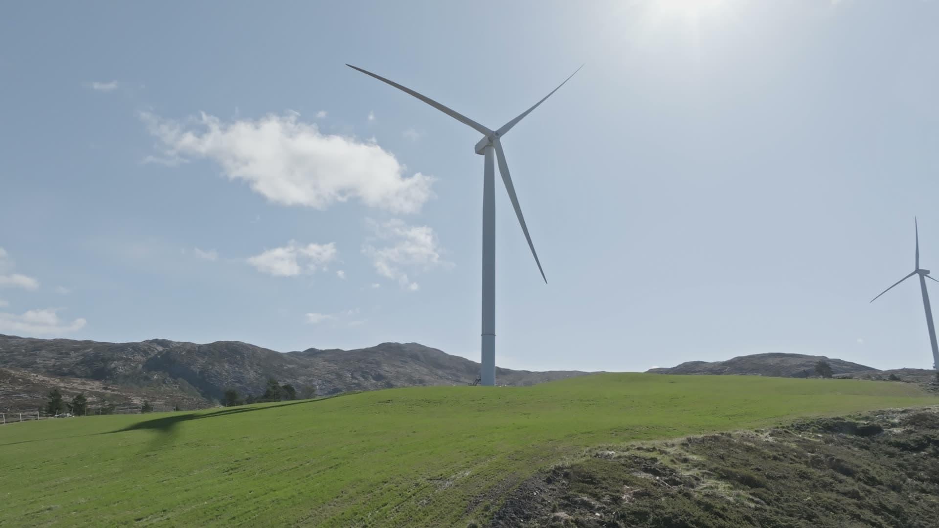 Wind turbines on green hillside, Fitjar