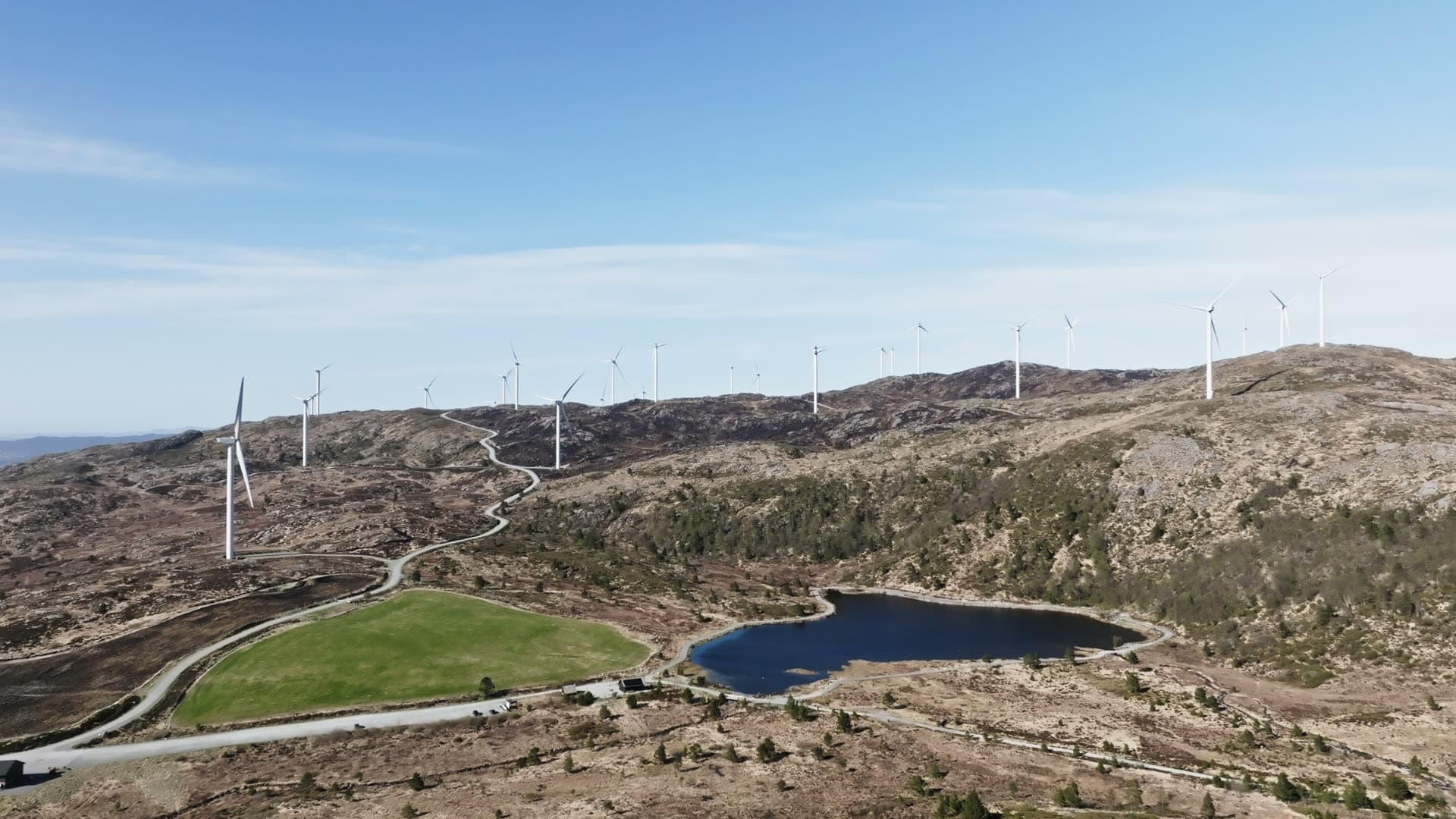 Wind turbines on alpine moorland with lake, Fitjar