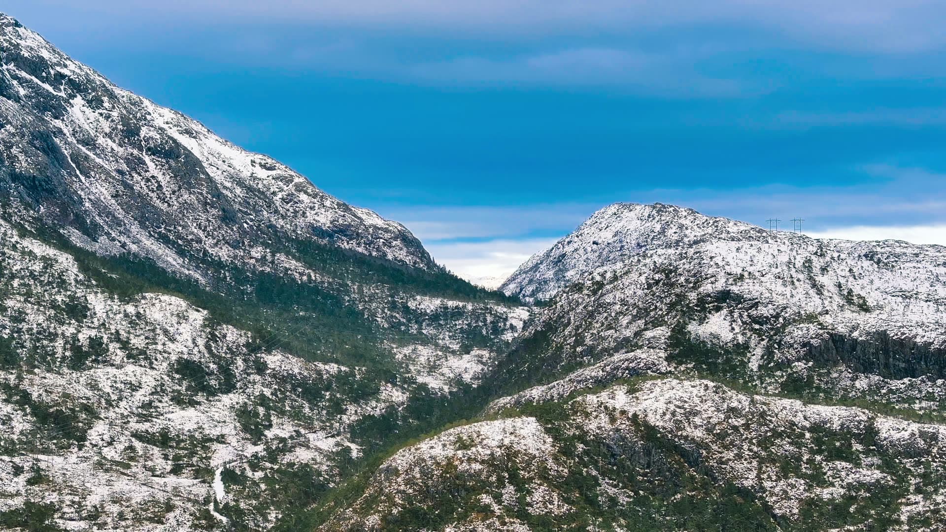 Snow-covered mountain valley with forest, Bergen