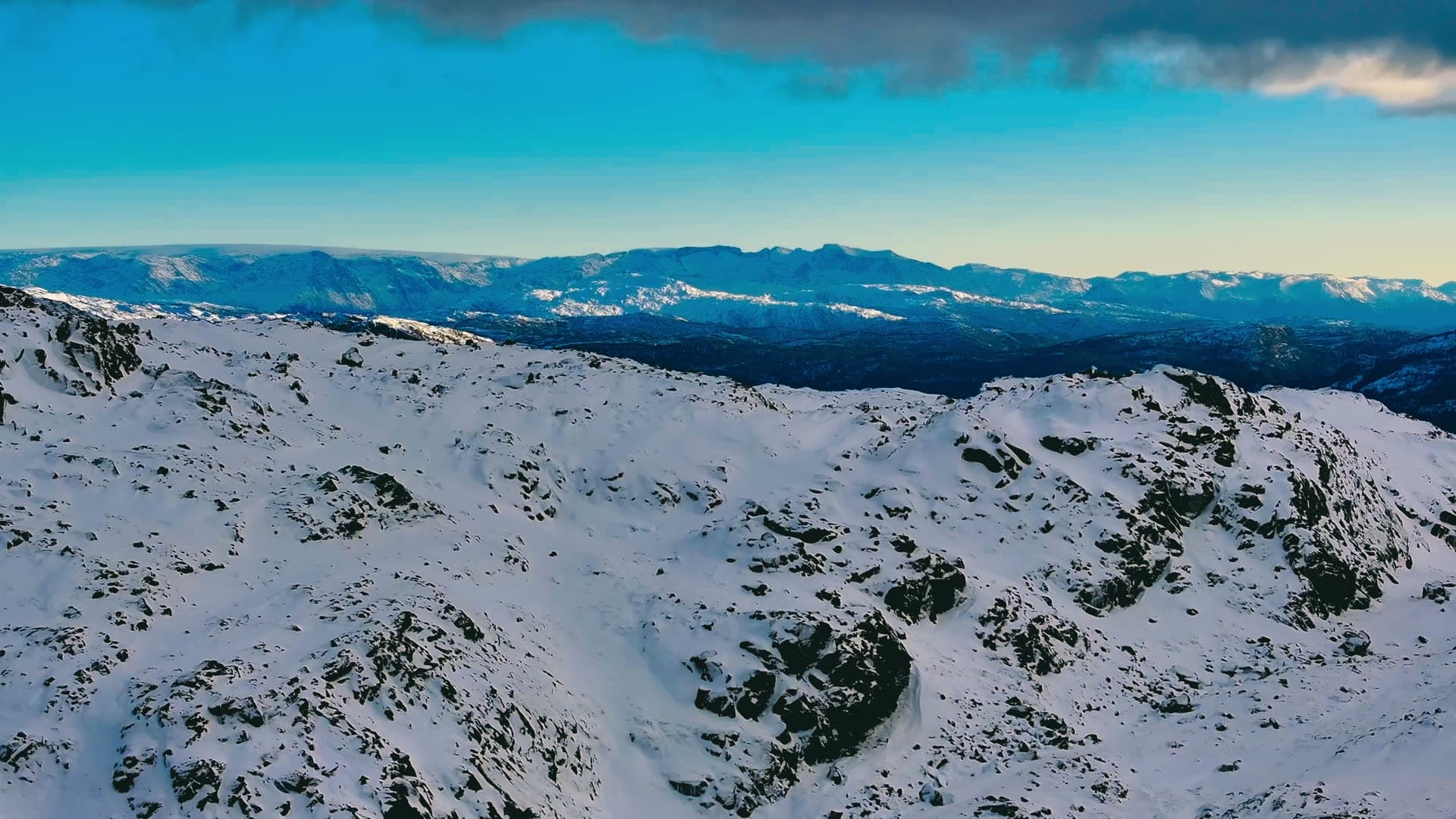 Snow-covered mountain range with distant valleys, Bergen