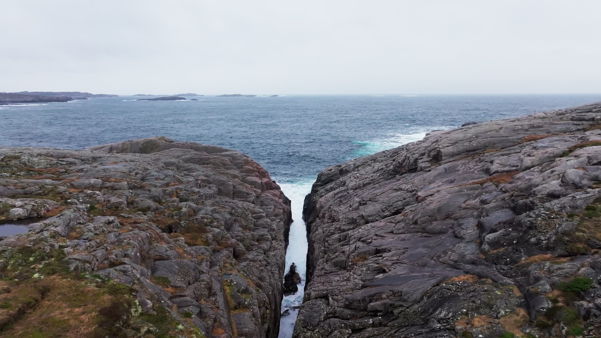 Rocky sea channel between cliff faces, Bergen