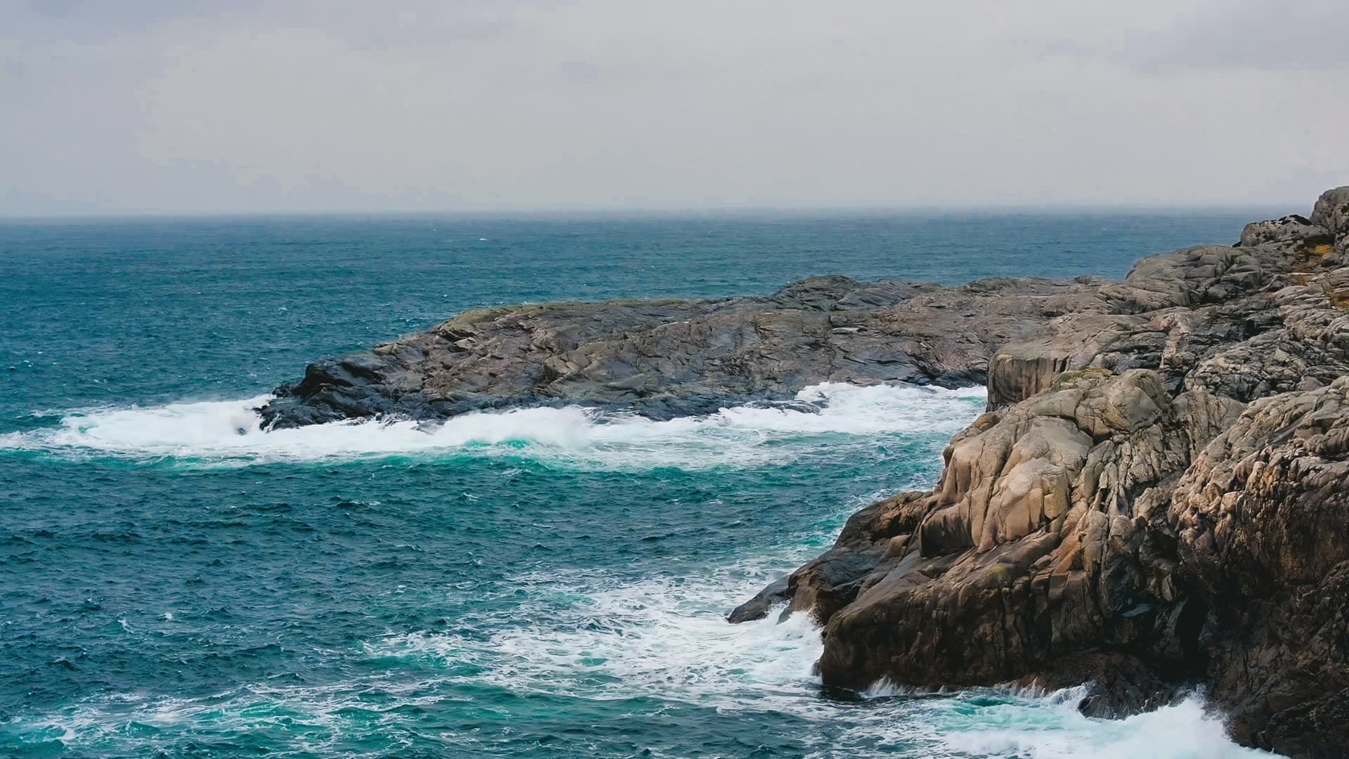 Rocky coastline with crashing waves, Bergen