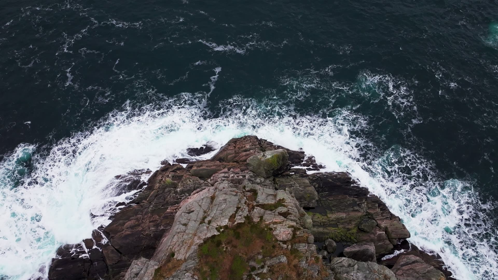 Waves crashing around rocky outcrop, Bergen