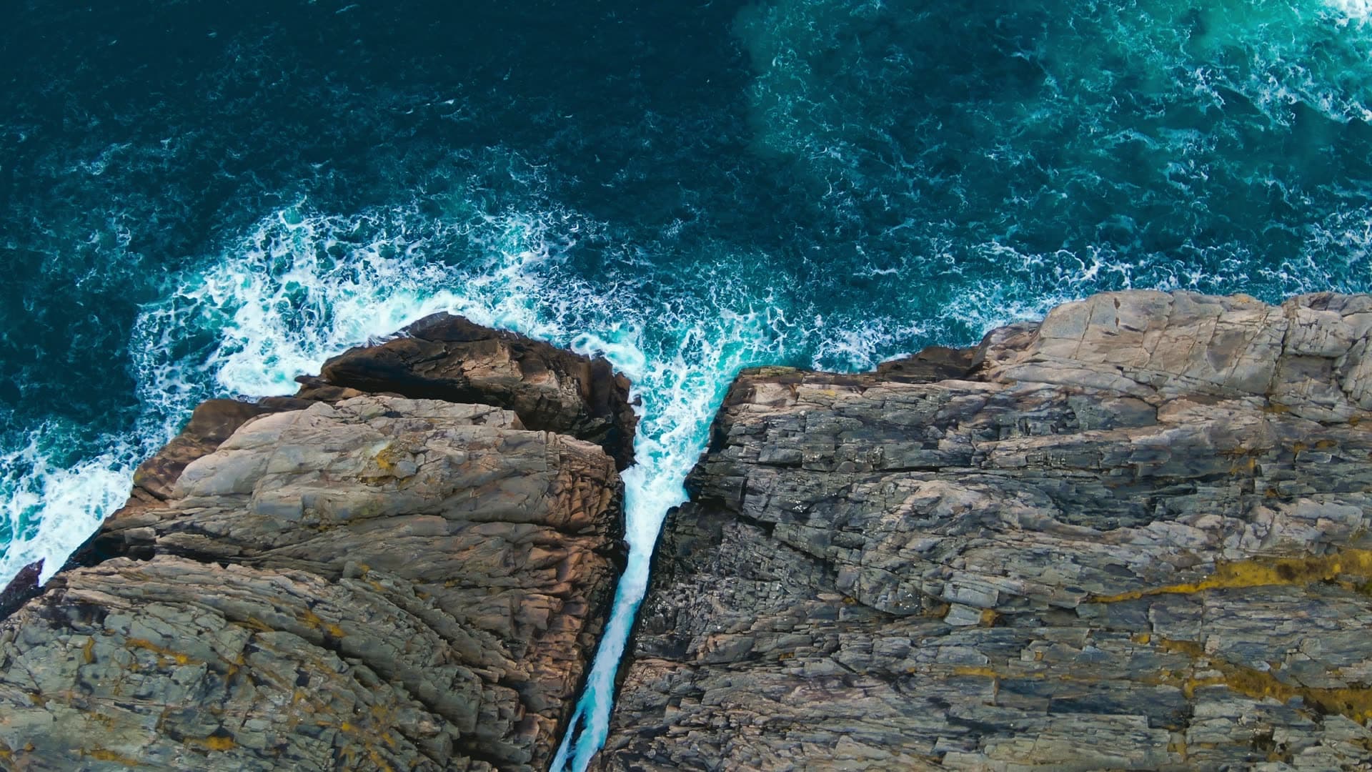 Waves crashing between split rock cliffs, Bergen