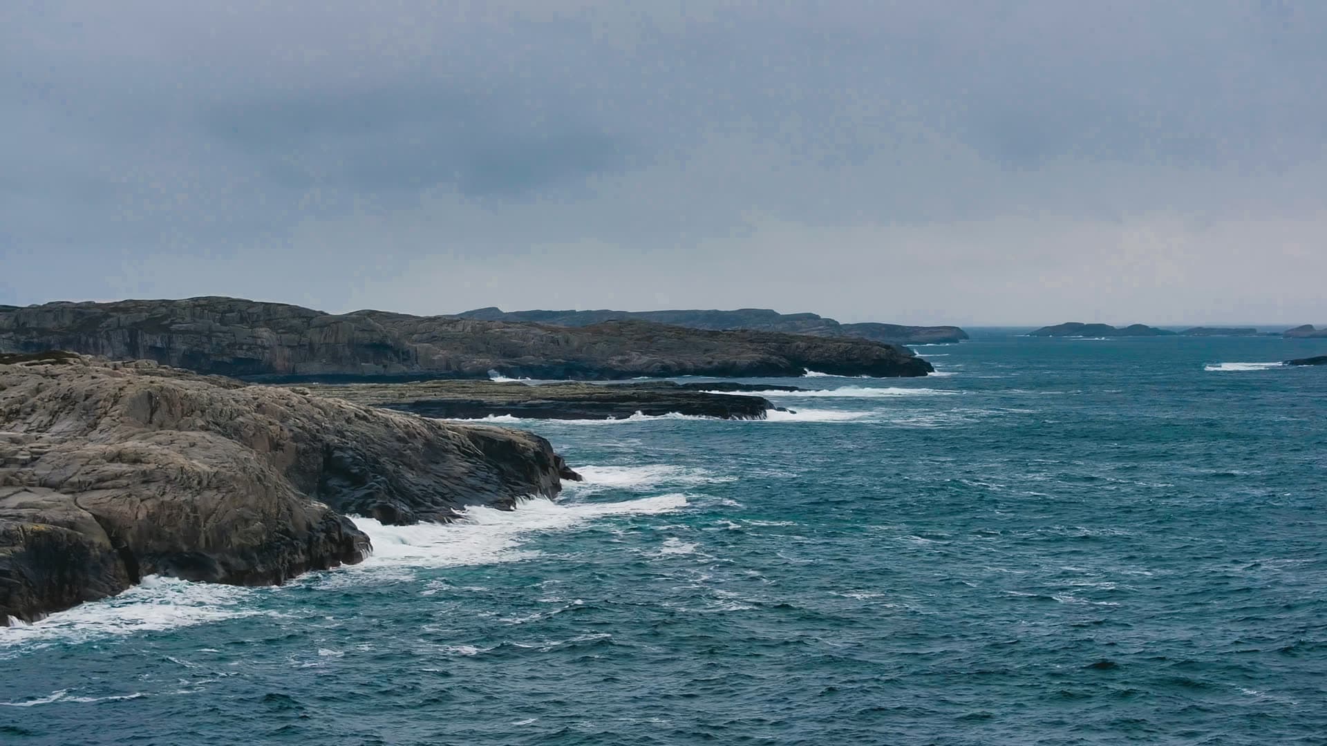 Rocky coastal headland with breaking waves, Bergen