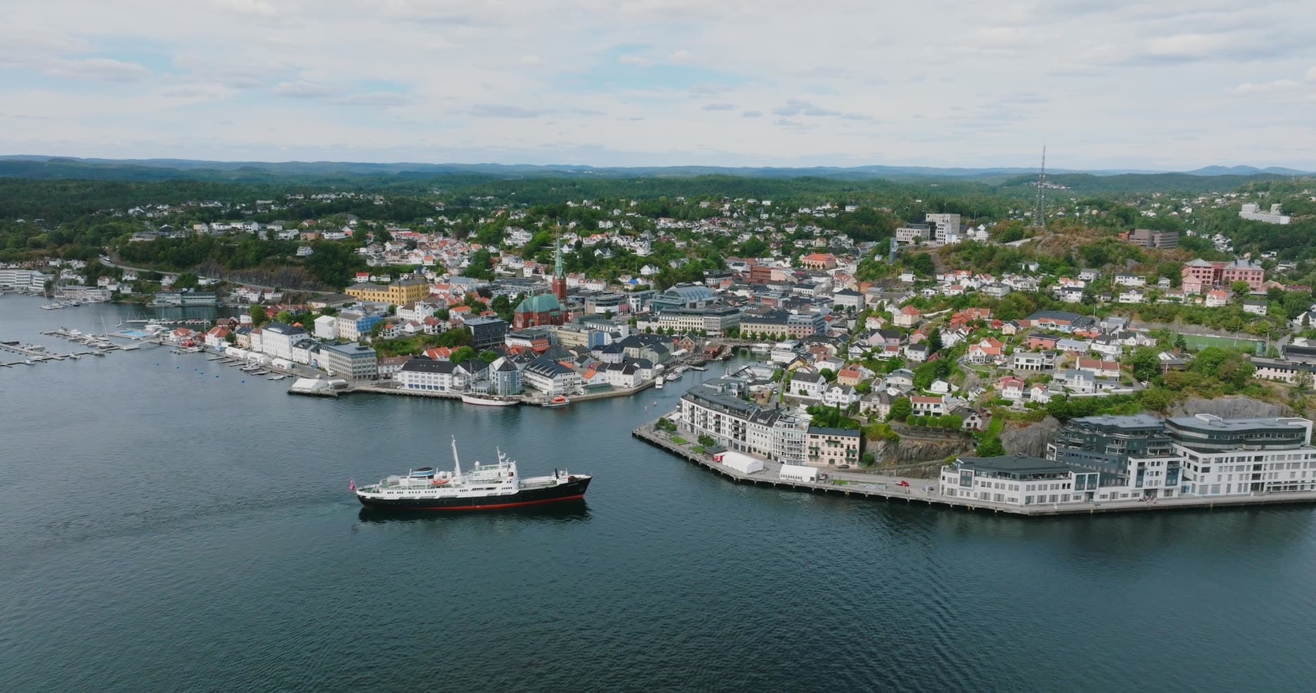 Black-hulled coastal steamer passing the town harbour, Arendal, Norway