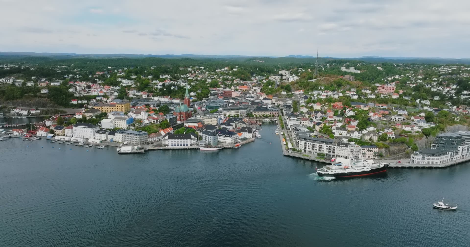 Black-hulled ship at the quay by the church, Arendal, Norway