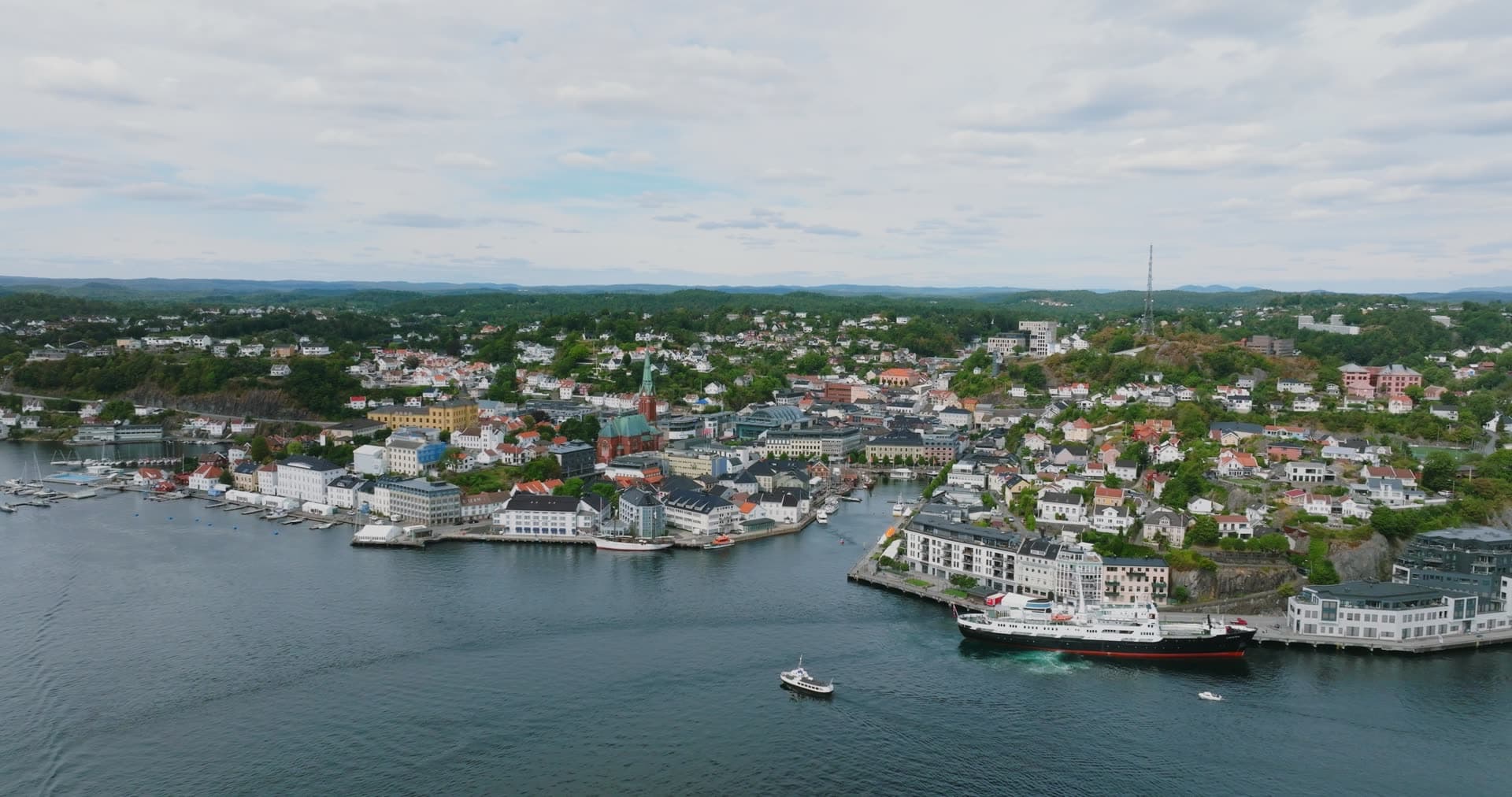 Black-hulled coastal steamer at quay and small ferry, Arendal, Norway