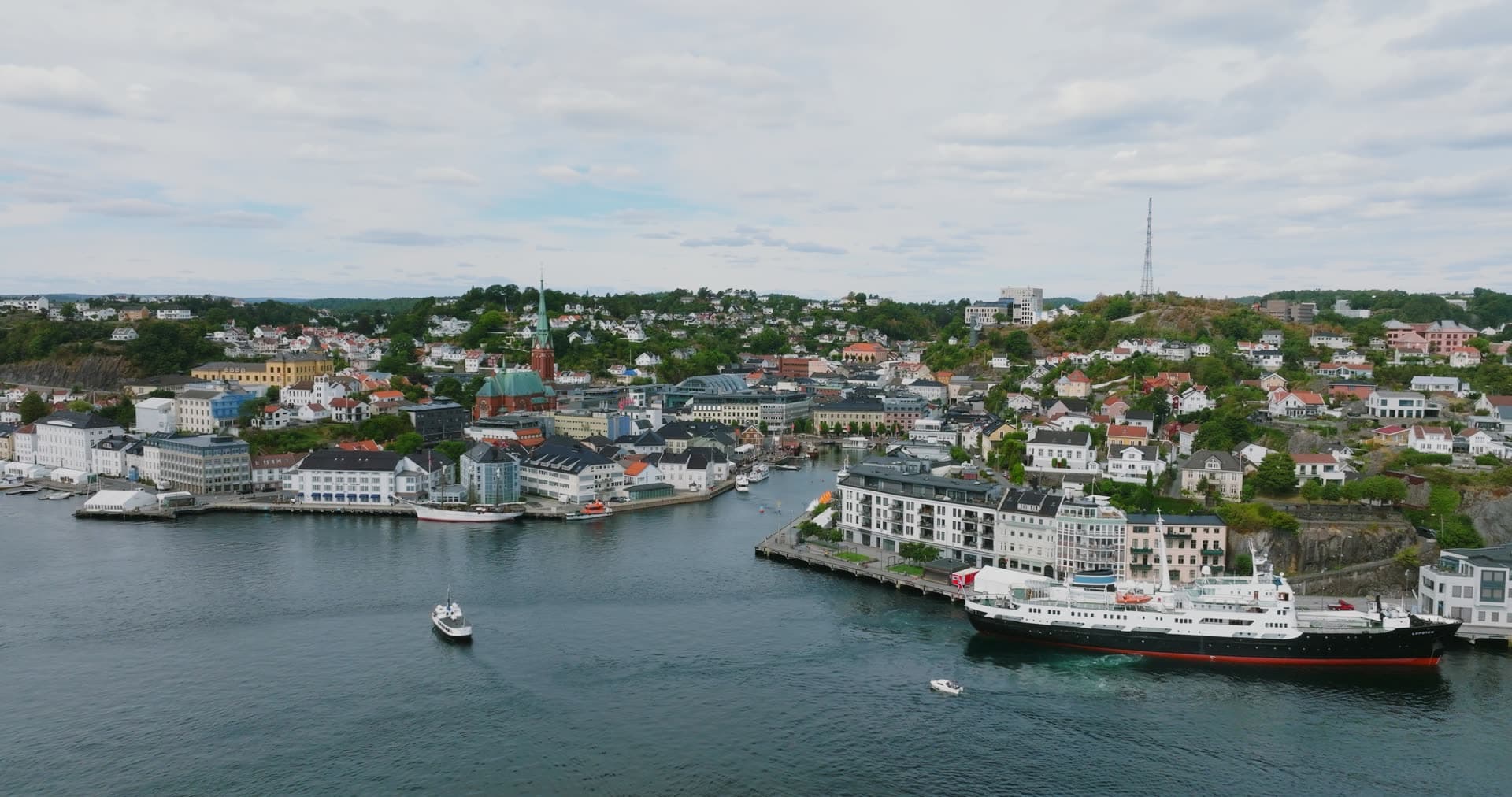 Classic steamship moored at quay across the harbour, Arendal, Norway