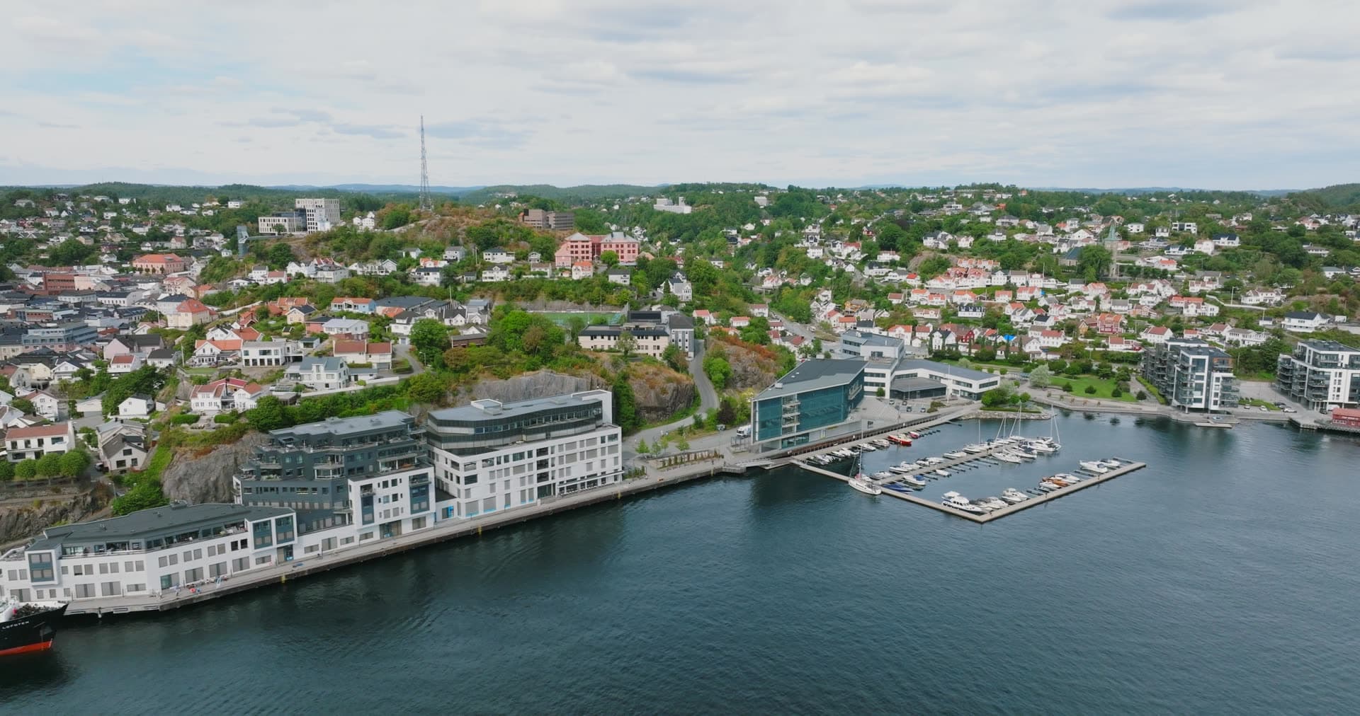 Waterfront quay, marina docks and hillside houses, Arendal, Norway