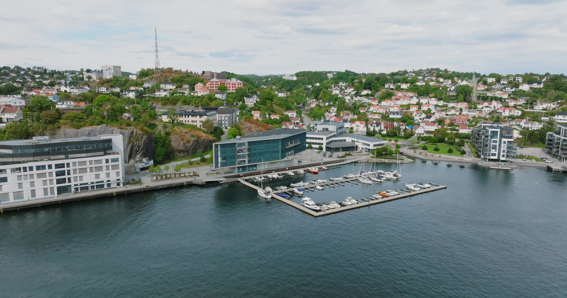 Marina pontoons below glass office block, Arendal, Norway
