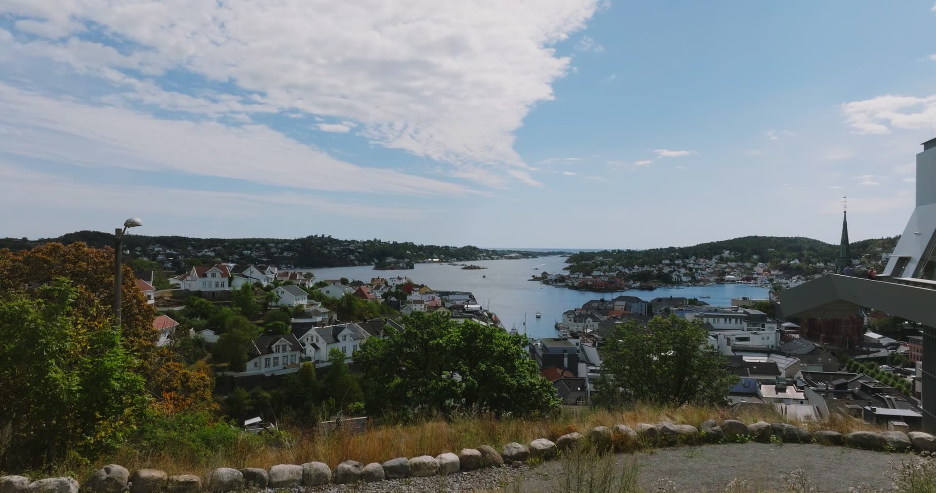 Hilltop view over white houses and church spire, Arendal, Norway