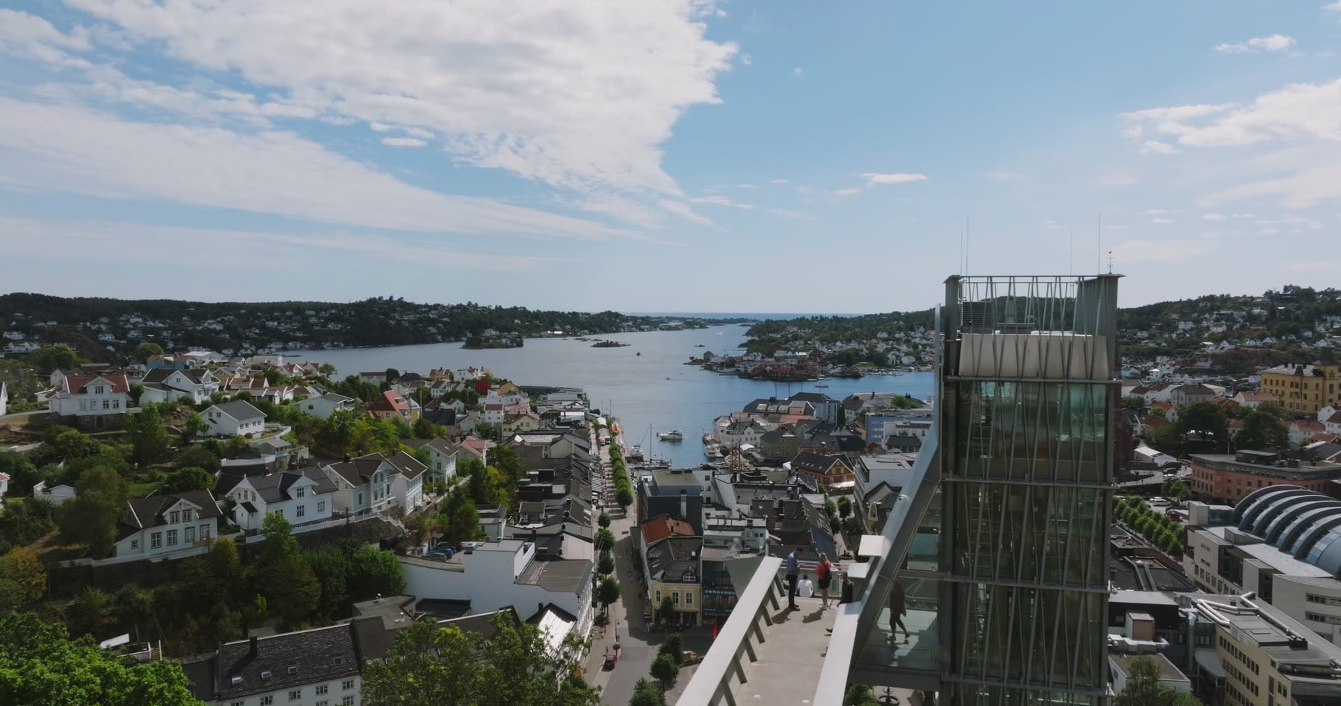 Glass elevator tower above town rooftops, Arendal, Norway