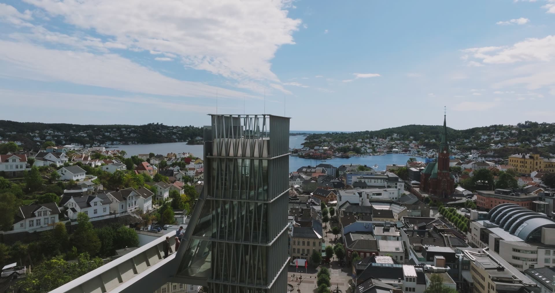 Glass tower rooftop terrace above town and church spire, Arendal, Norway