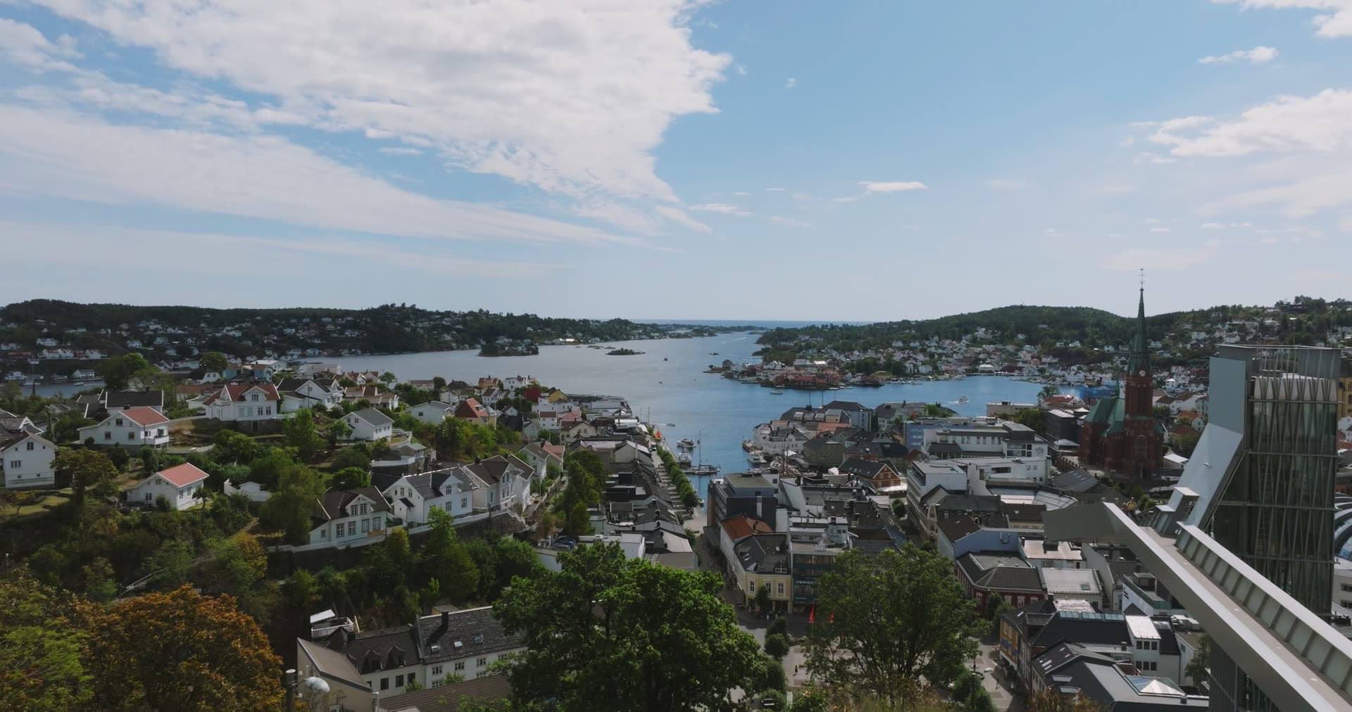 Church spire and glass tower above the harbour inlet, Arendal, Norway