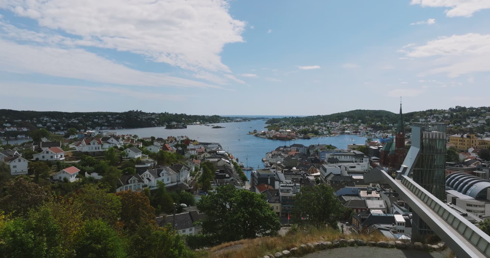 Church spire and glass tower over harbour, Arendal, Norway