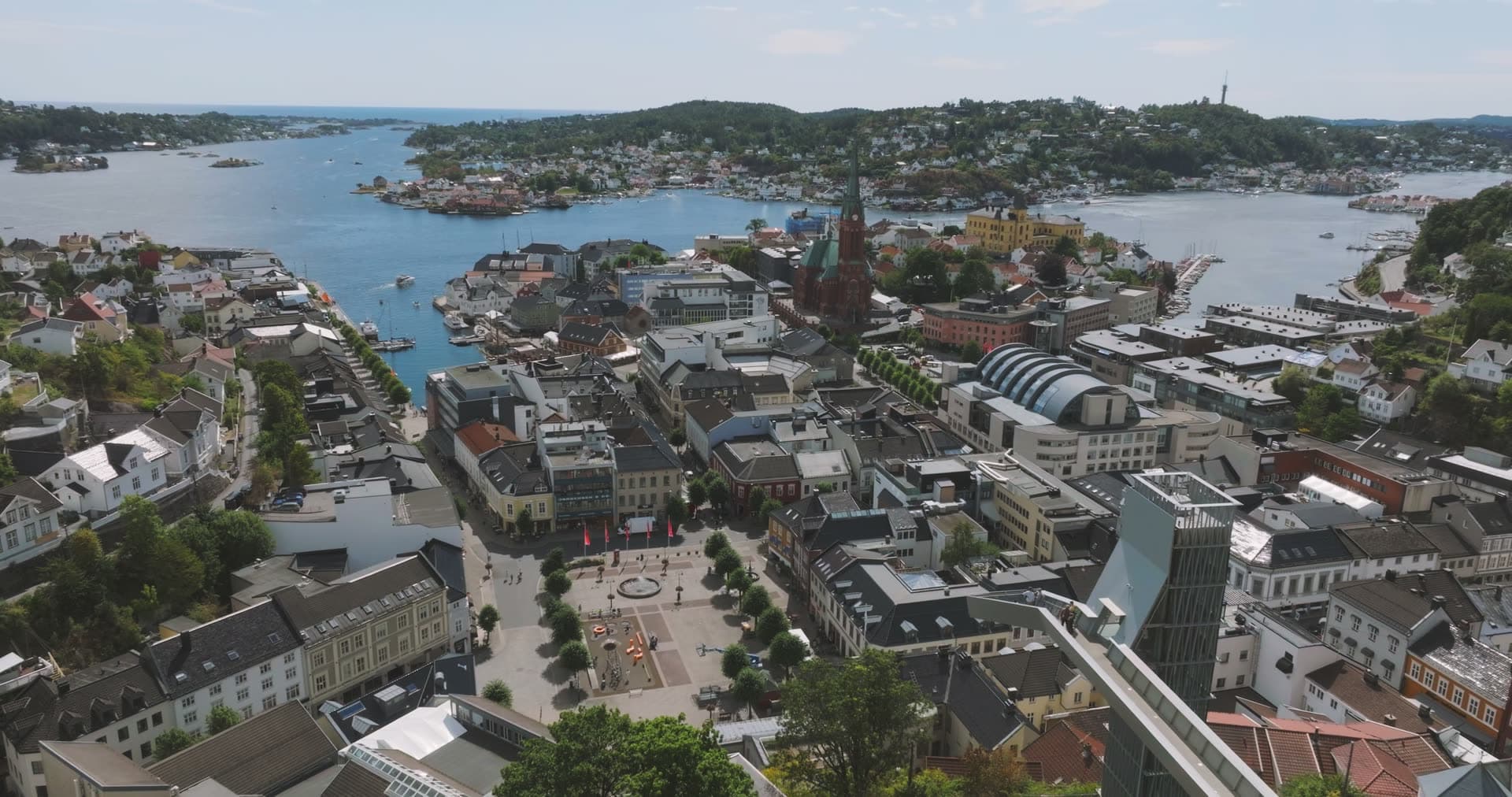 Town square, church spire and glass tower, Arendal, Norway