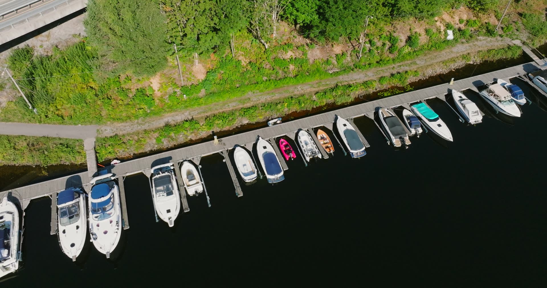 Top-down row of boats along a long dock, Bomsholmen, Norway
