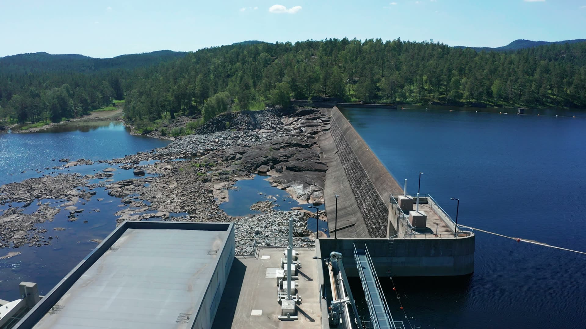 Concrete dam wall and dry rocky riverbed, Bøylefoss, Norway