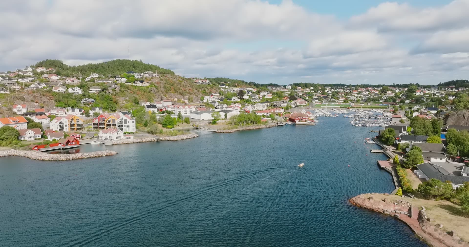 Small boat wake in inlet toward marina, Fevik, Norway