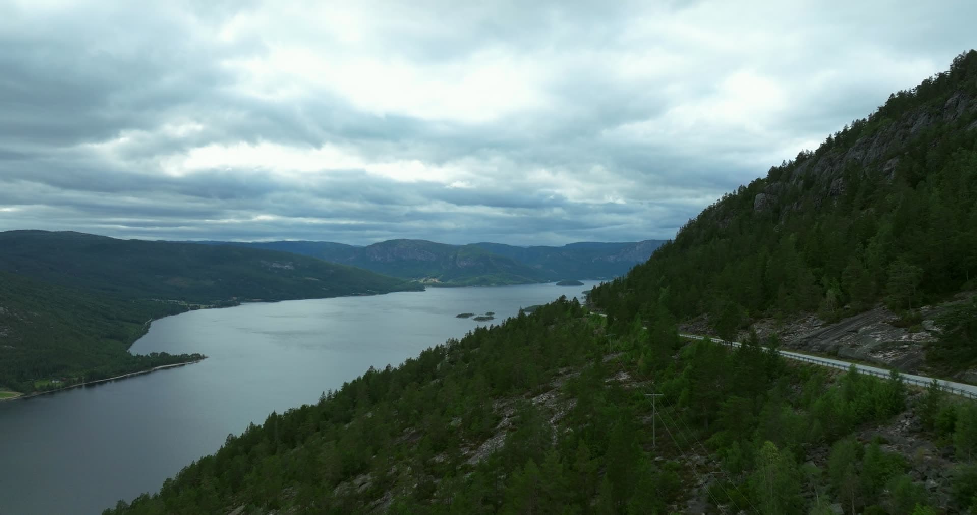 Hillside road above lake with wooded islets, Fyresdal, Norway