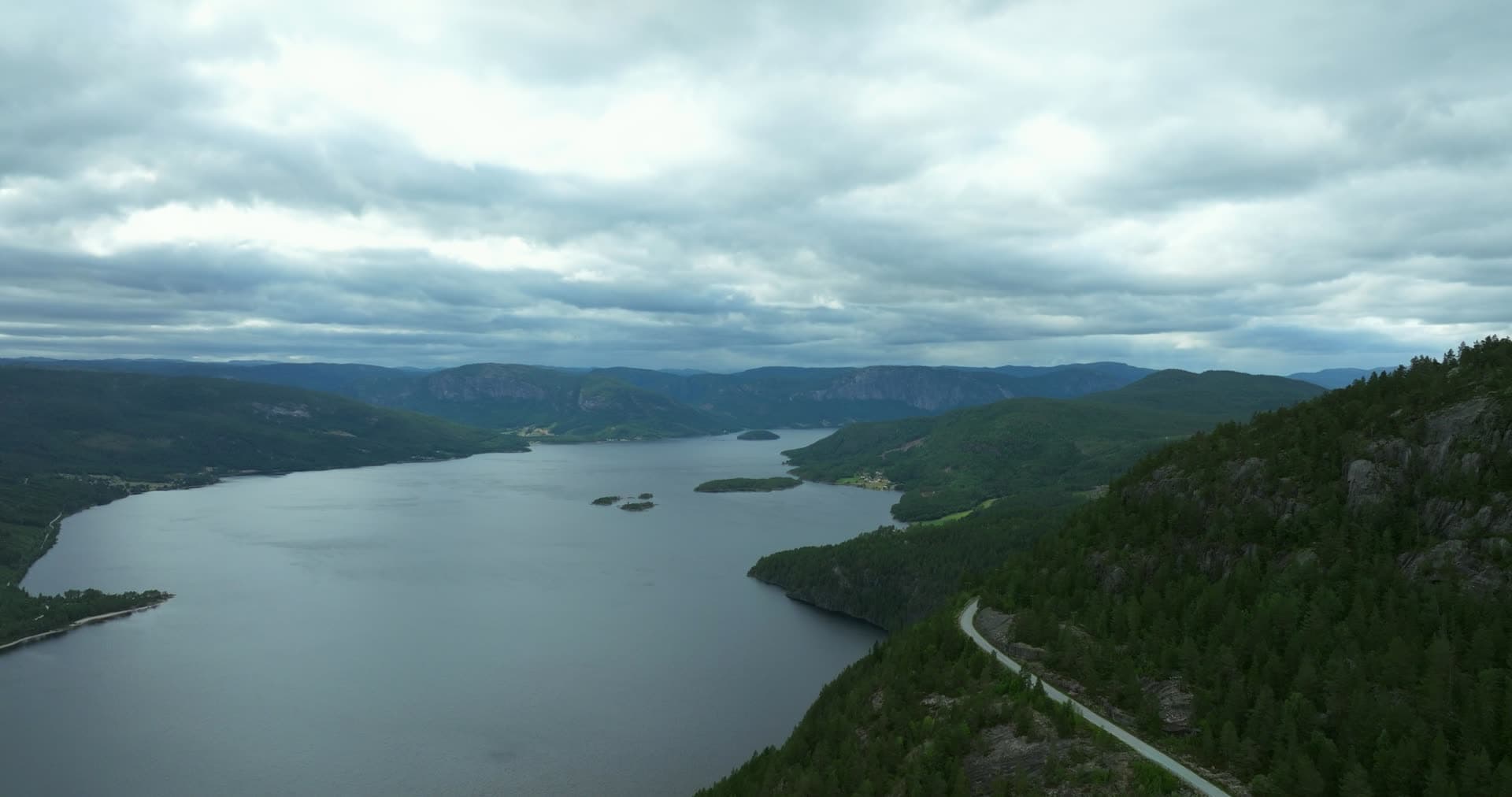 Hillside road above lake with small islets, Fyresdal, Norway