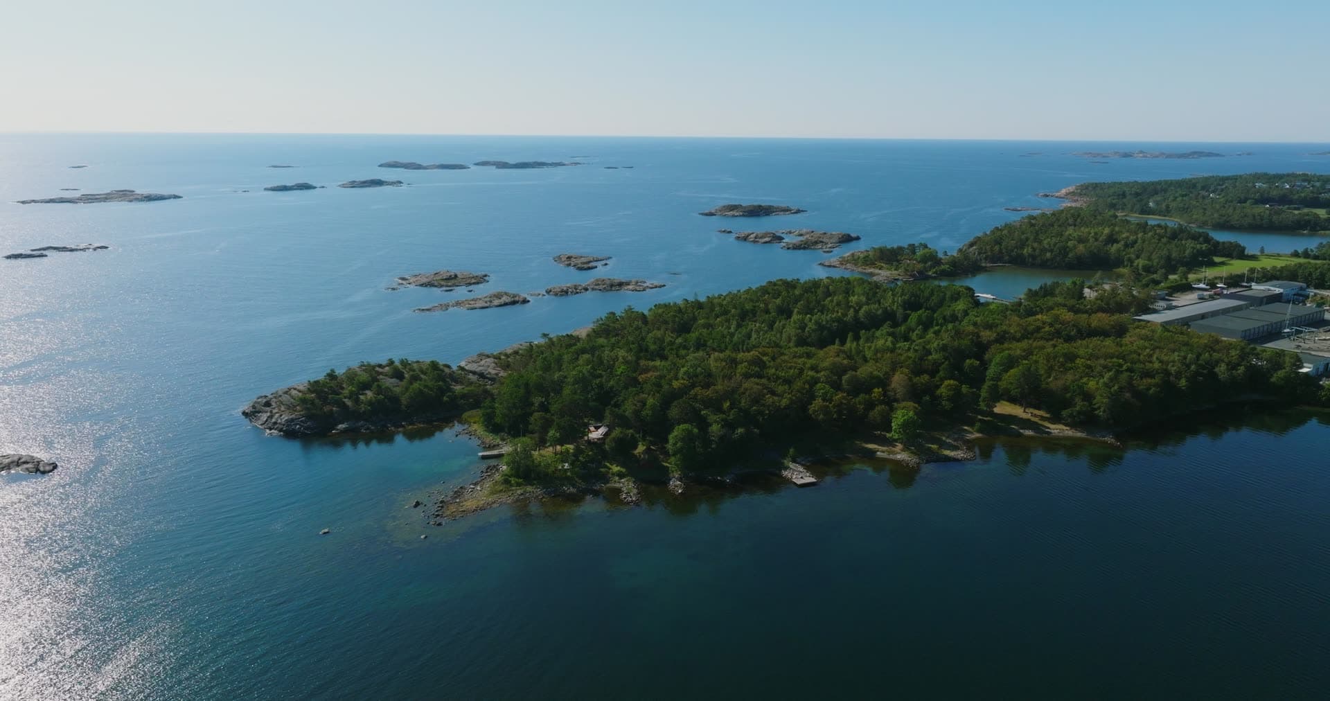 Wooded headland tip and bare skerries, Hasseltangen, Norway