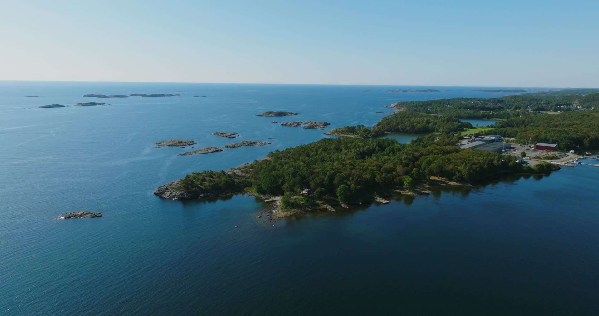 Wooded headland and skerries off open sea, Hasseltangen, Norway