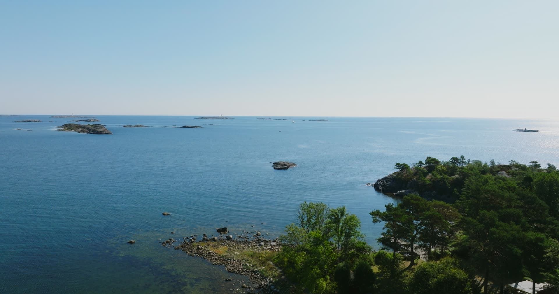 Wooded headland past skerries and open sea, Hasseltangen, Norway