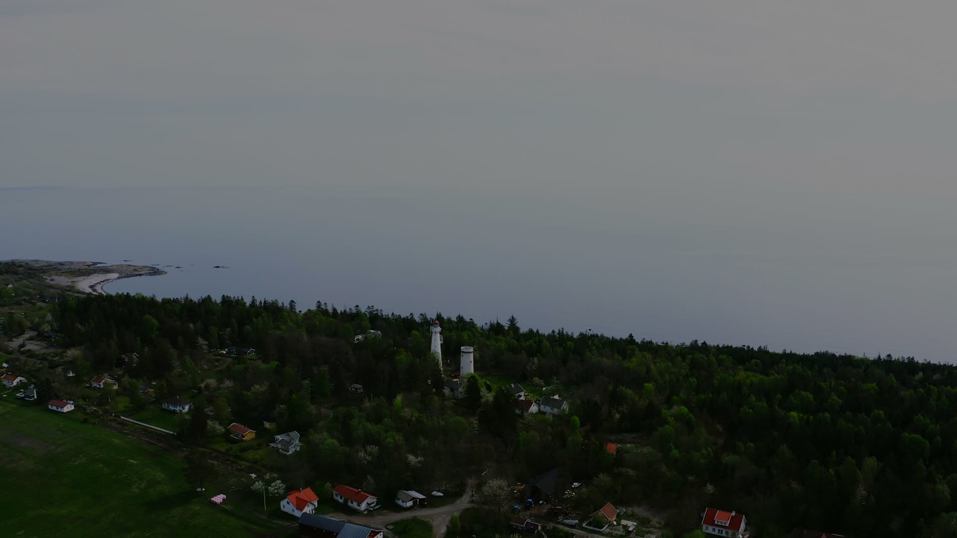 Two lighthouse towers above wooded shore, Jomfruland, Norway