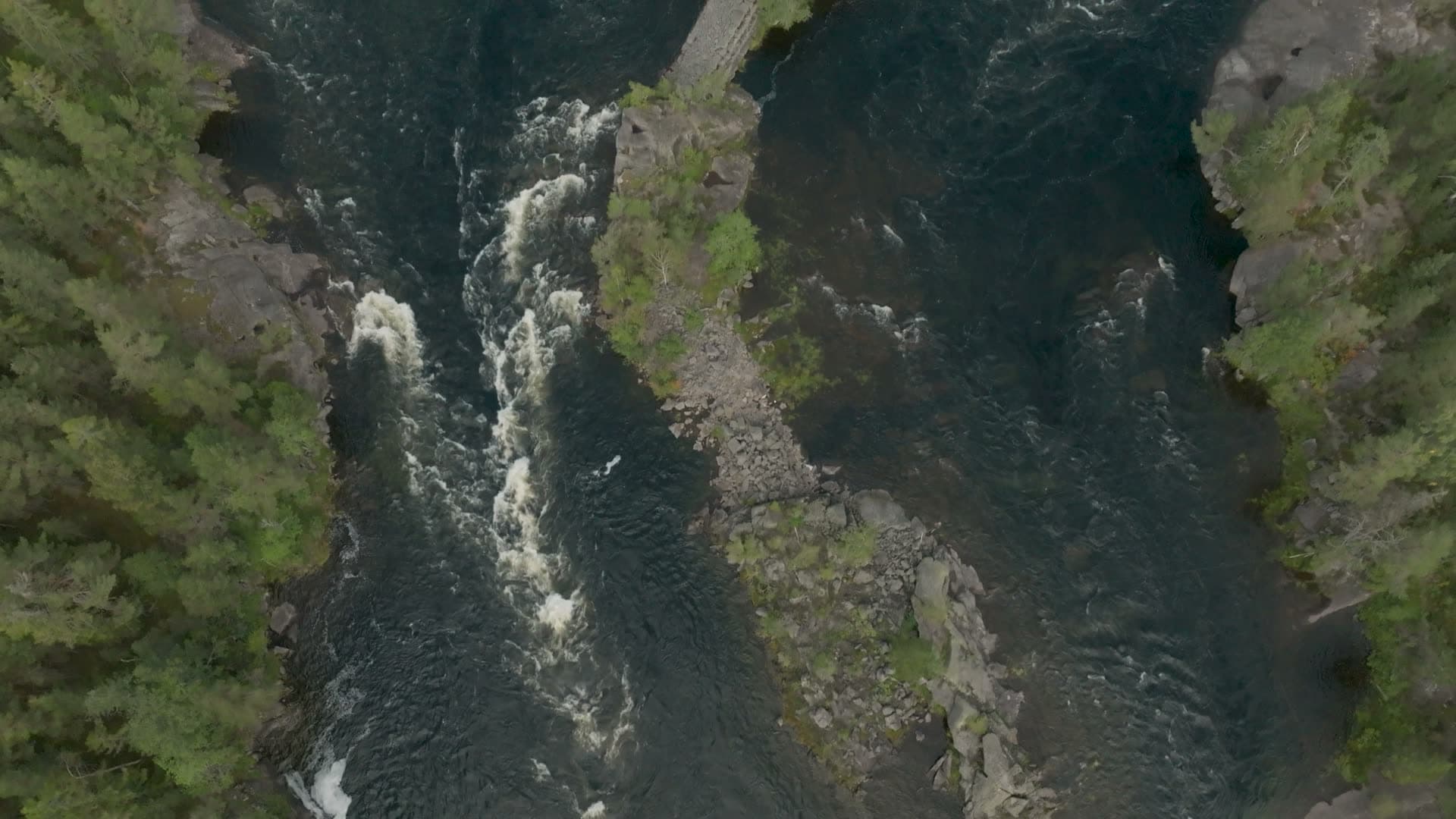 River rapids splitting around rocky ledge, Kilandsfoss, Norway