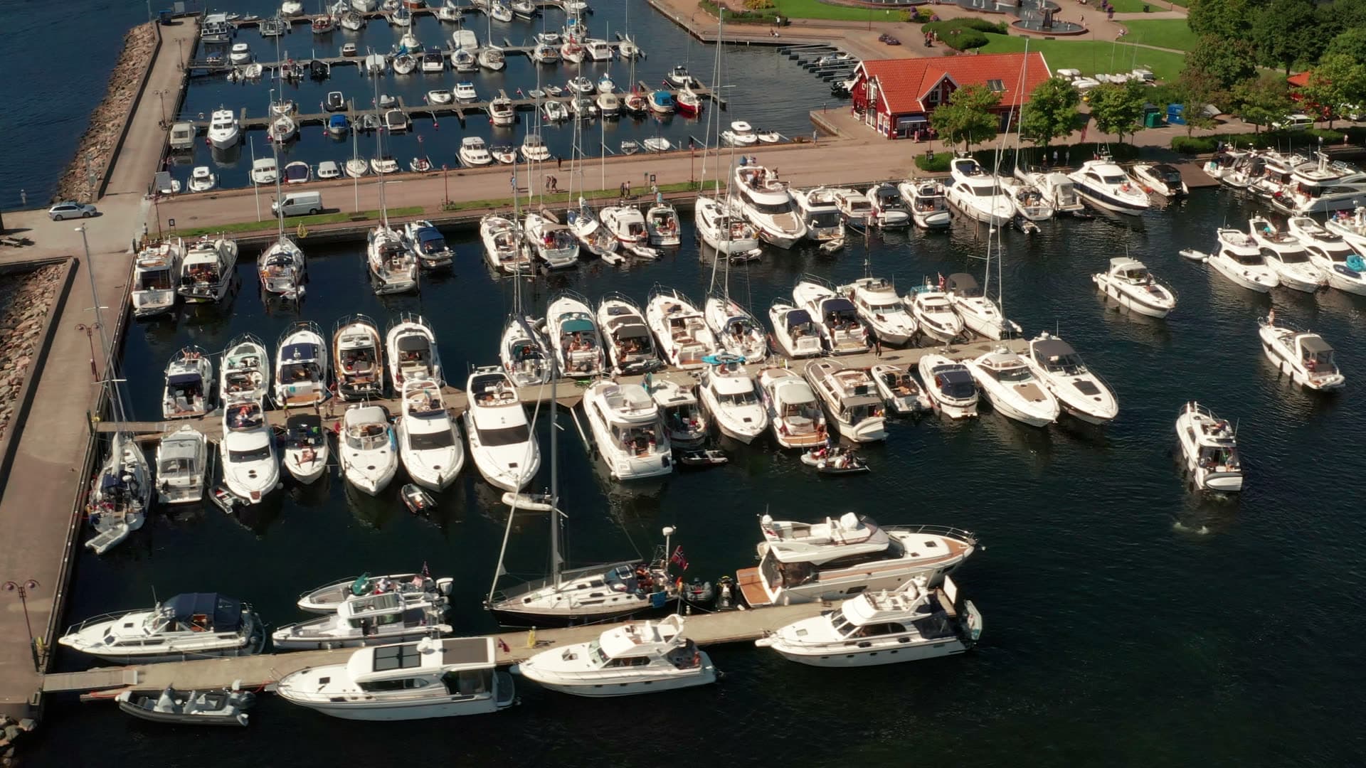 Motorboat leaving packed marina basin, Kristiansand, Norway