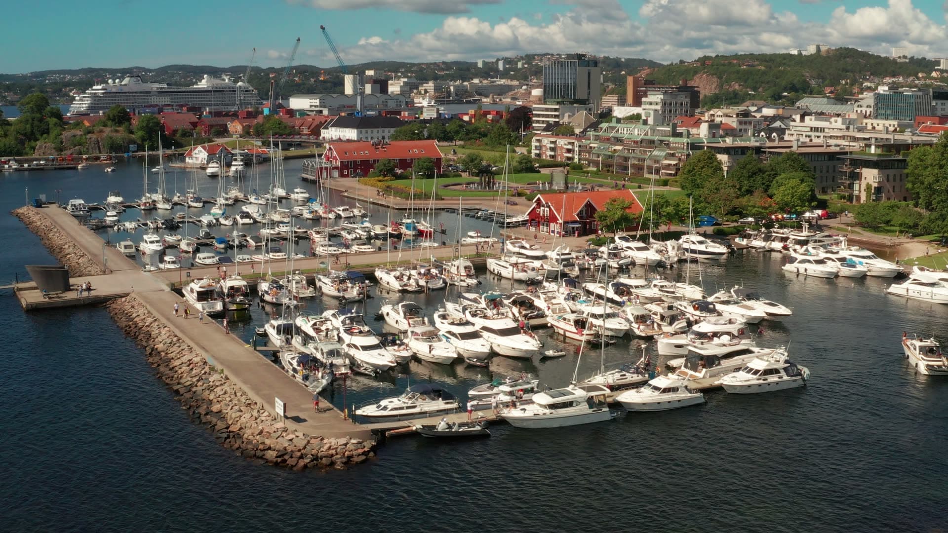 Marina behind rock breakwater, cruise ship, Kristiansand, Norway
