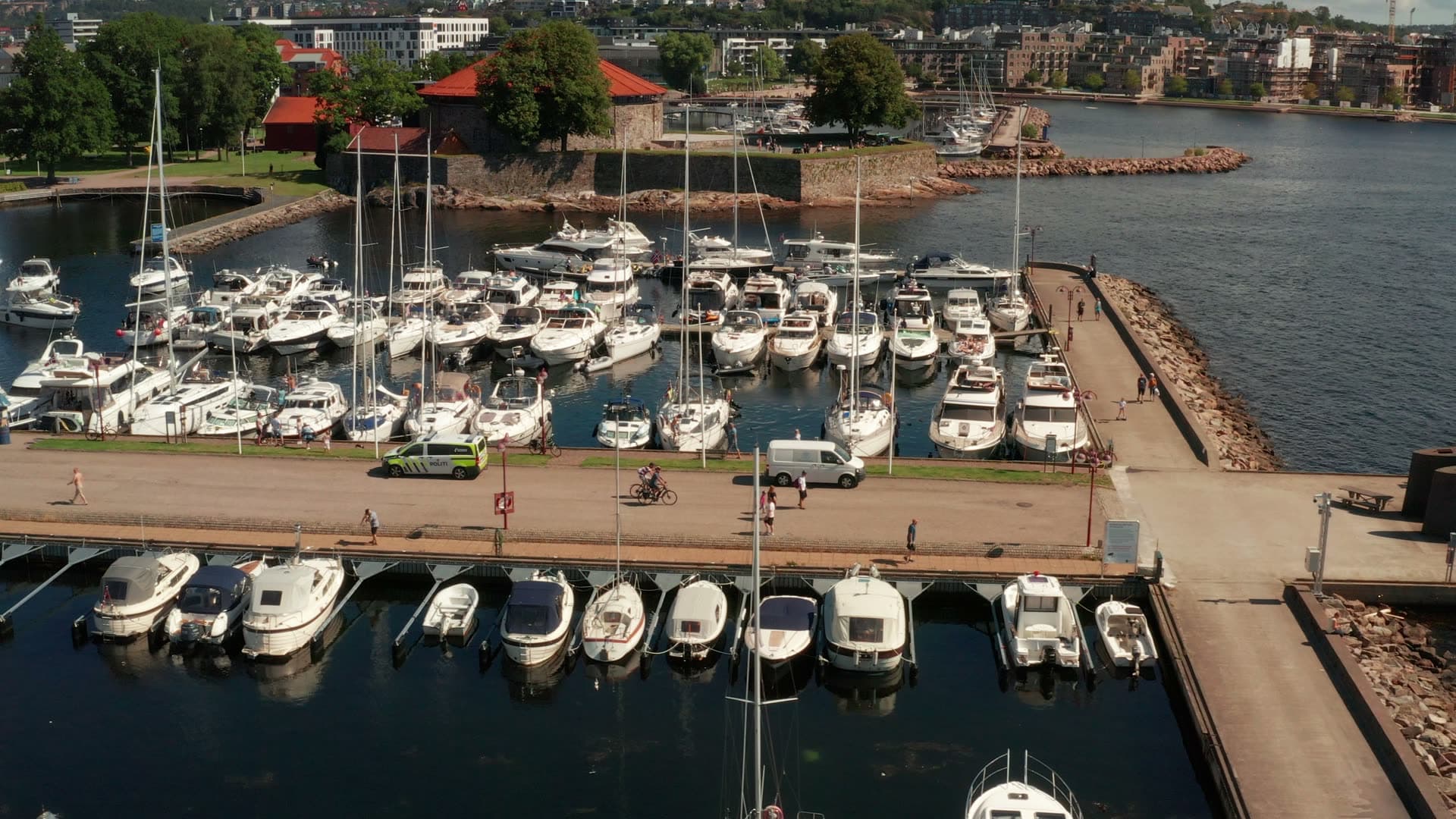 Marina pier walkway past moored boats, Kristiansand, Norway