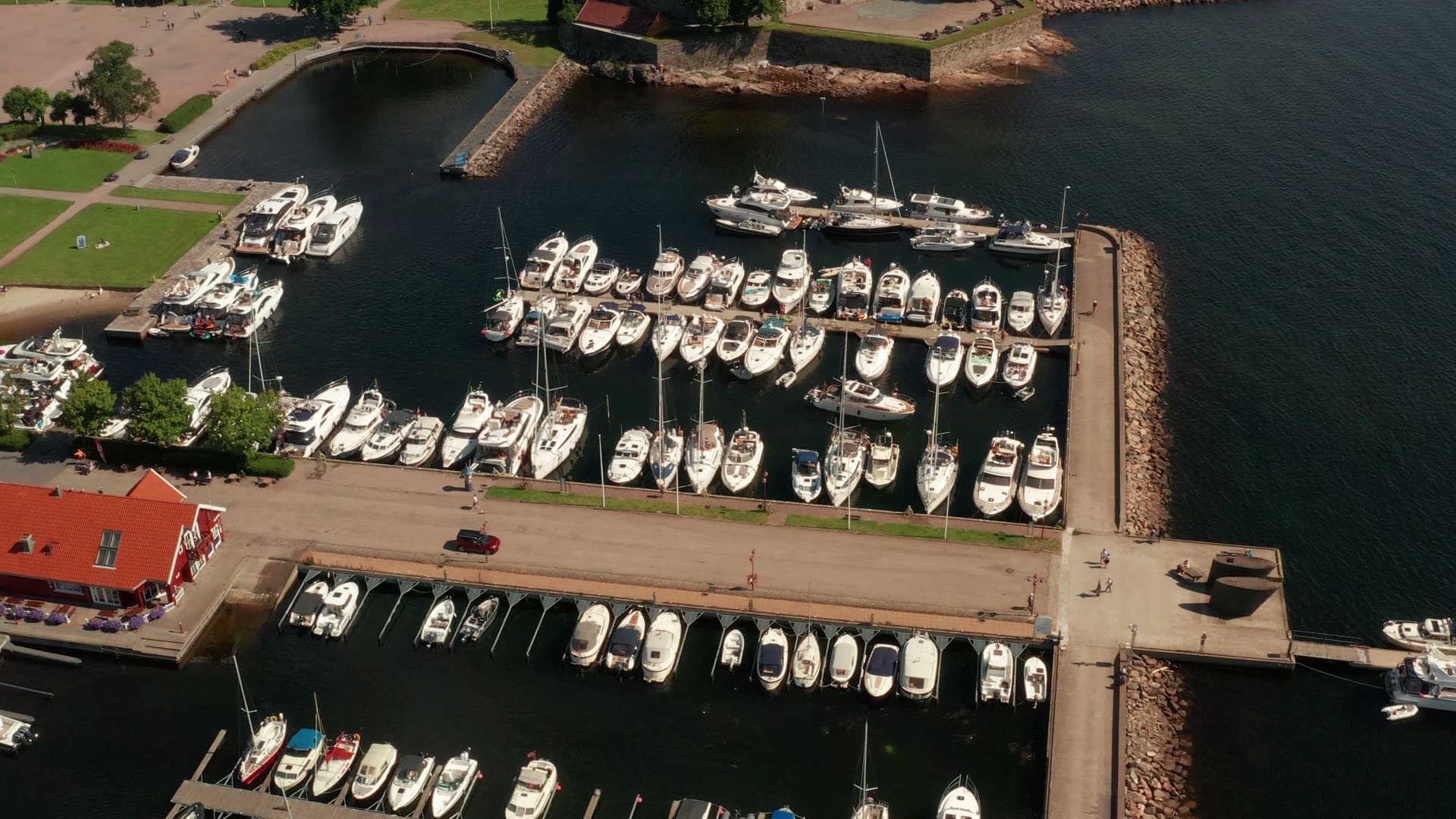 Marina behind rock breakwater, red-roof cafe, Kristiansand, Norway