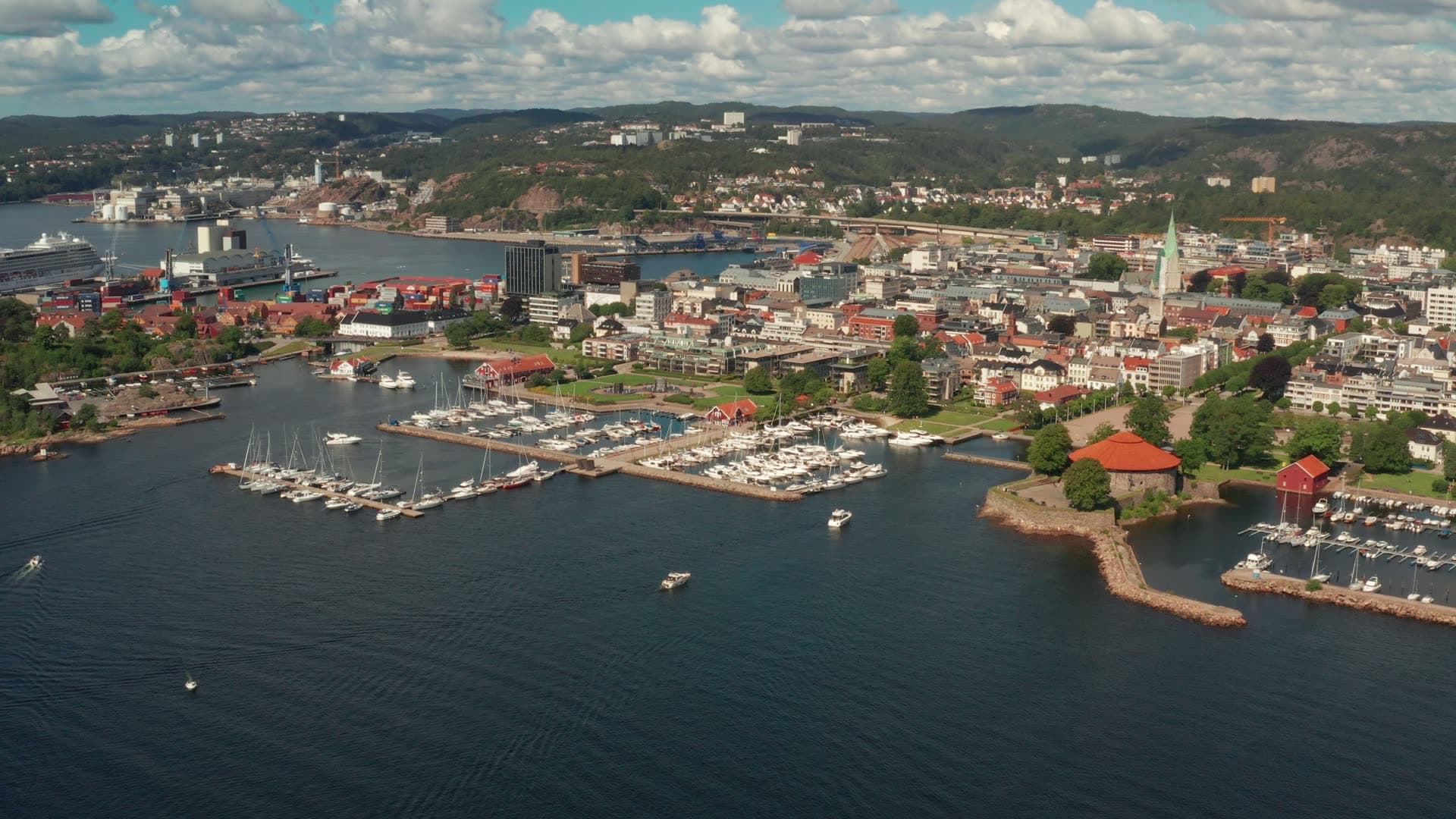 Marina and round red-roofed fort by town, Kristiansand, Norway