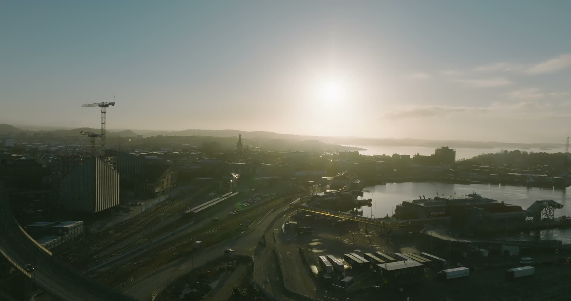 Rail yard, port and tower crane into the sun, Kristiansand, Norway