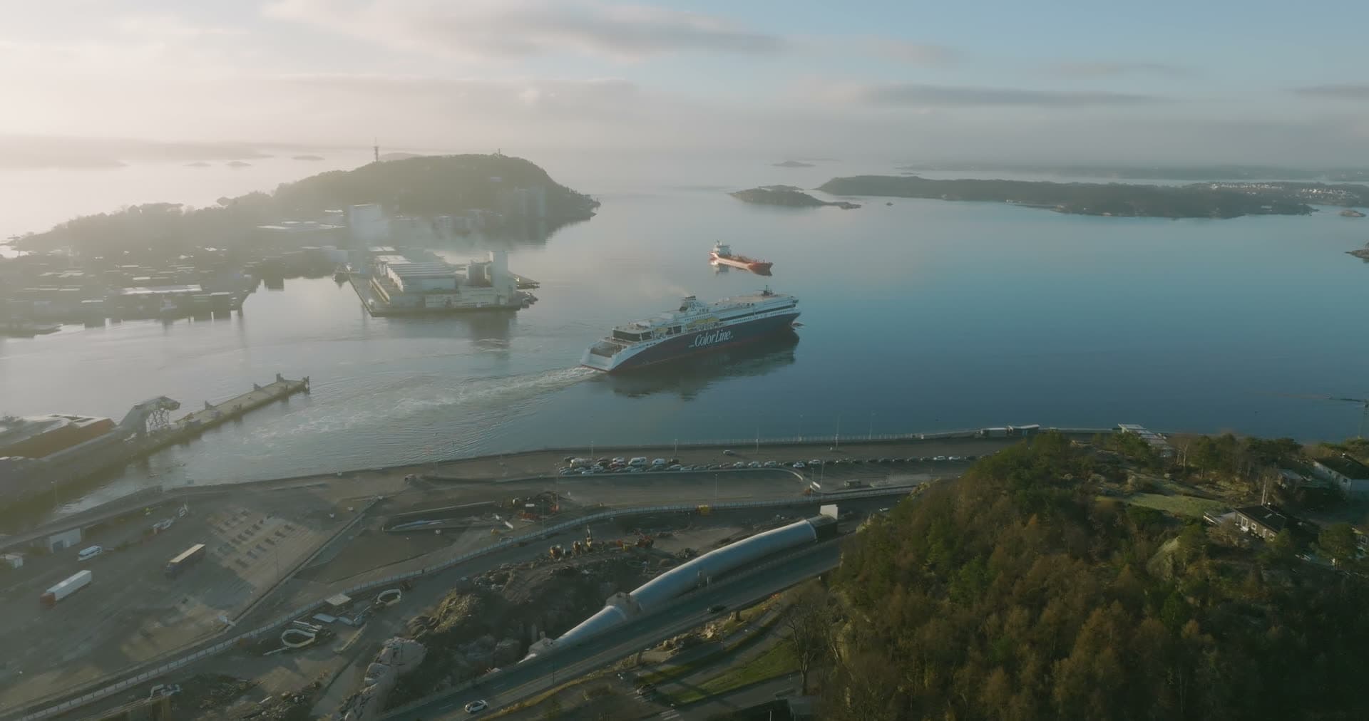 Misty islands and ferry in the sound, Kristiansand, Norway