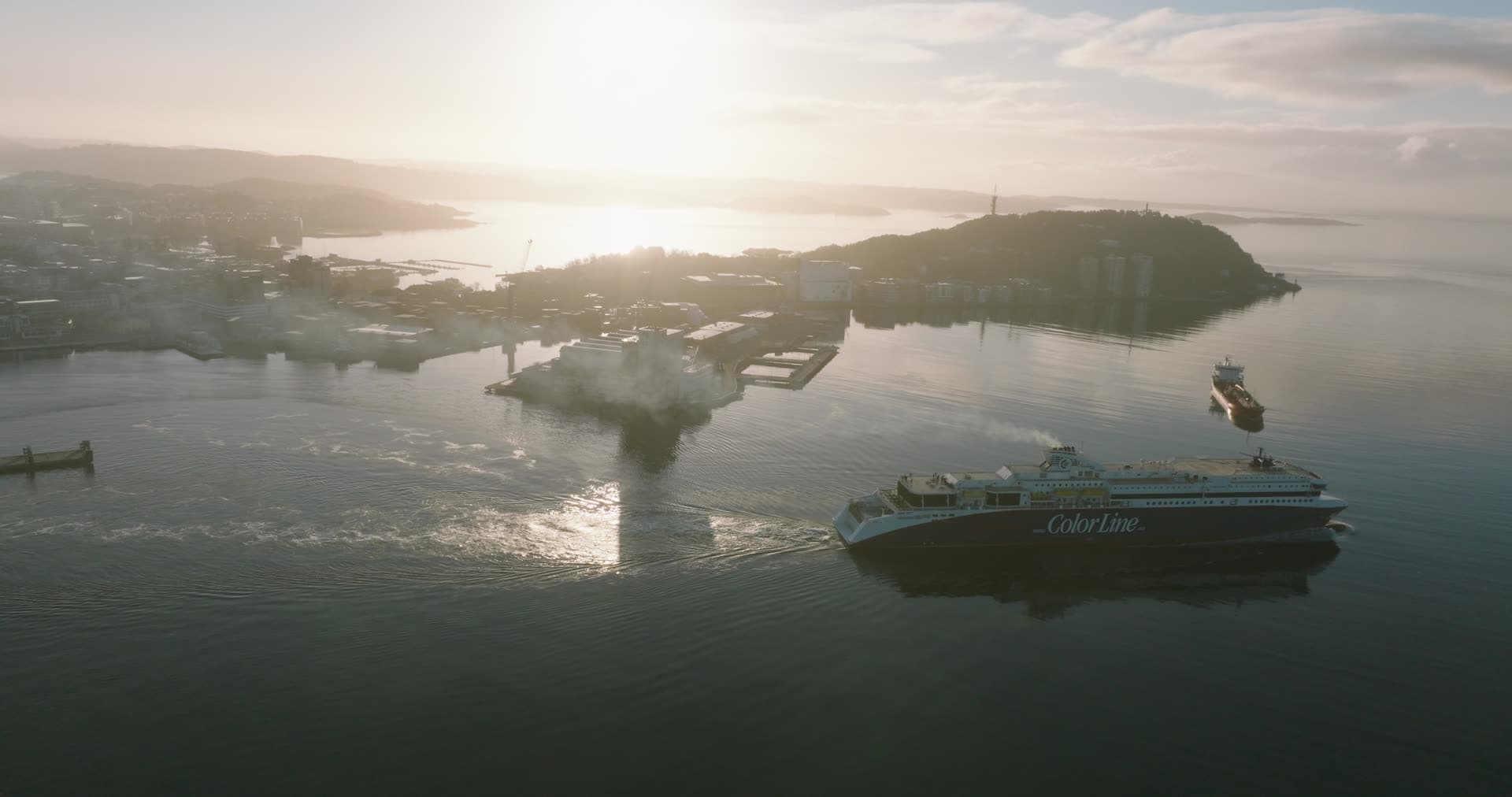 Passenger ferry leaving the harbour at sunrise, Kristiansand, Norway