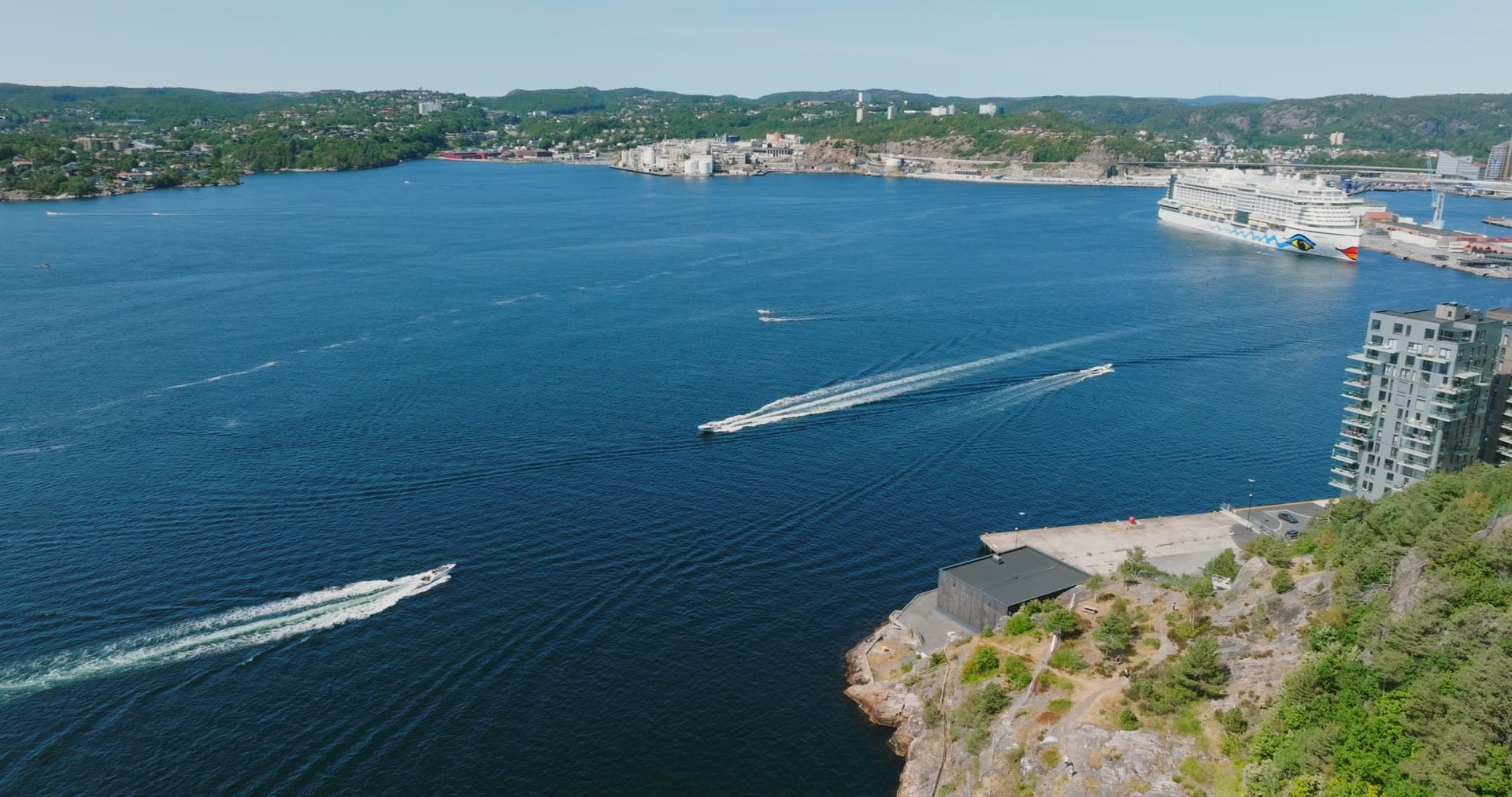 Speedboat wakes and cruise ship at port, Kristiansand, Norway