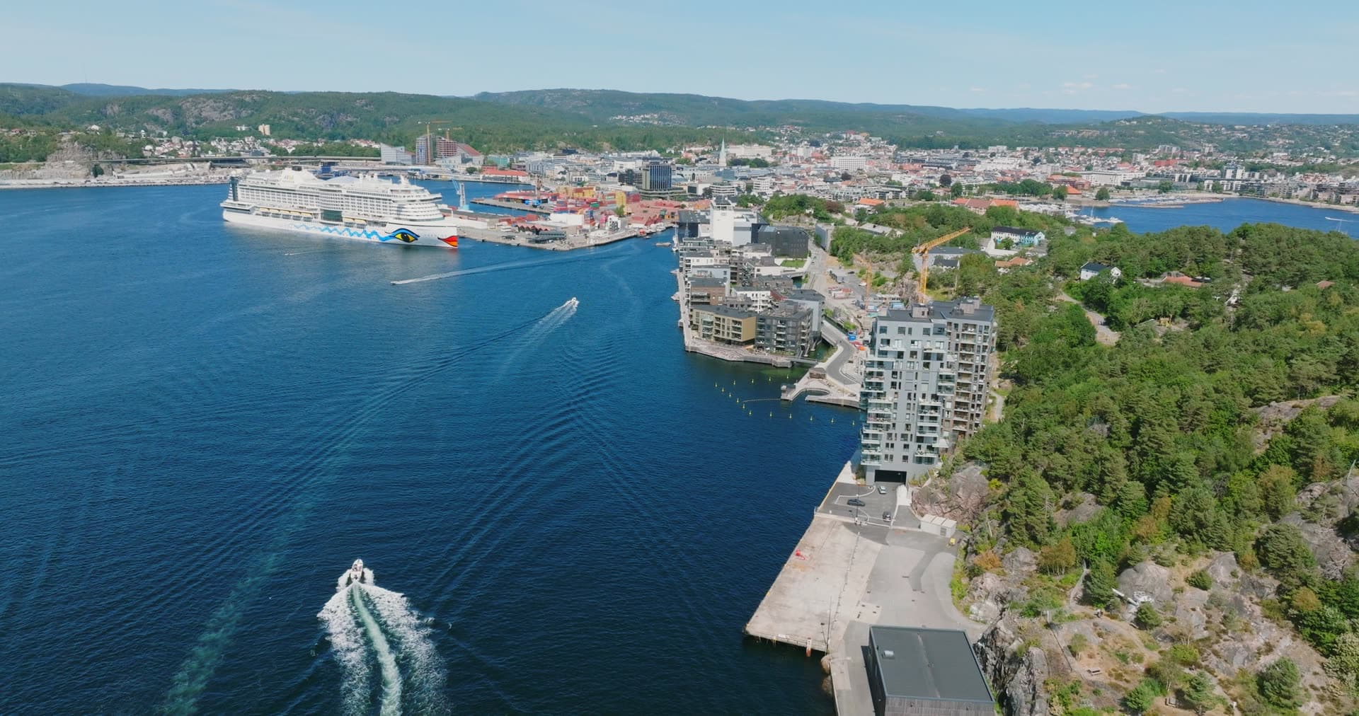 Cruise ship at quay and speedboat wake, Kristiansand, Norway